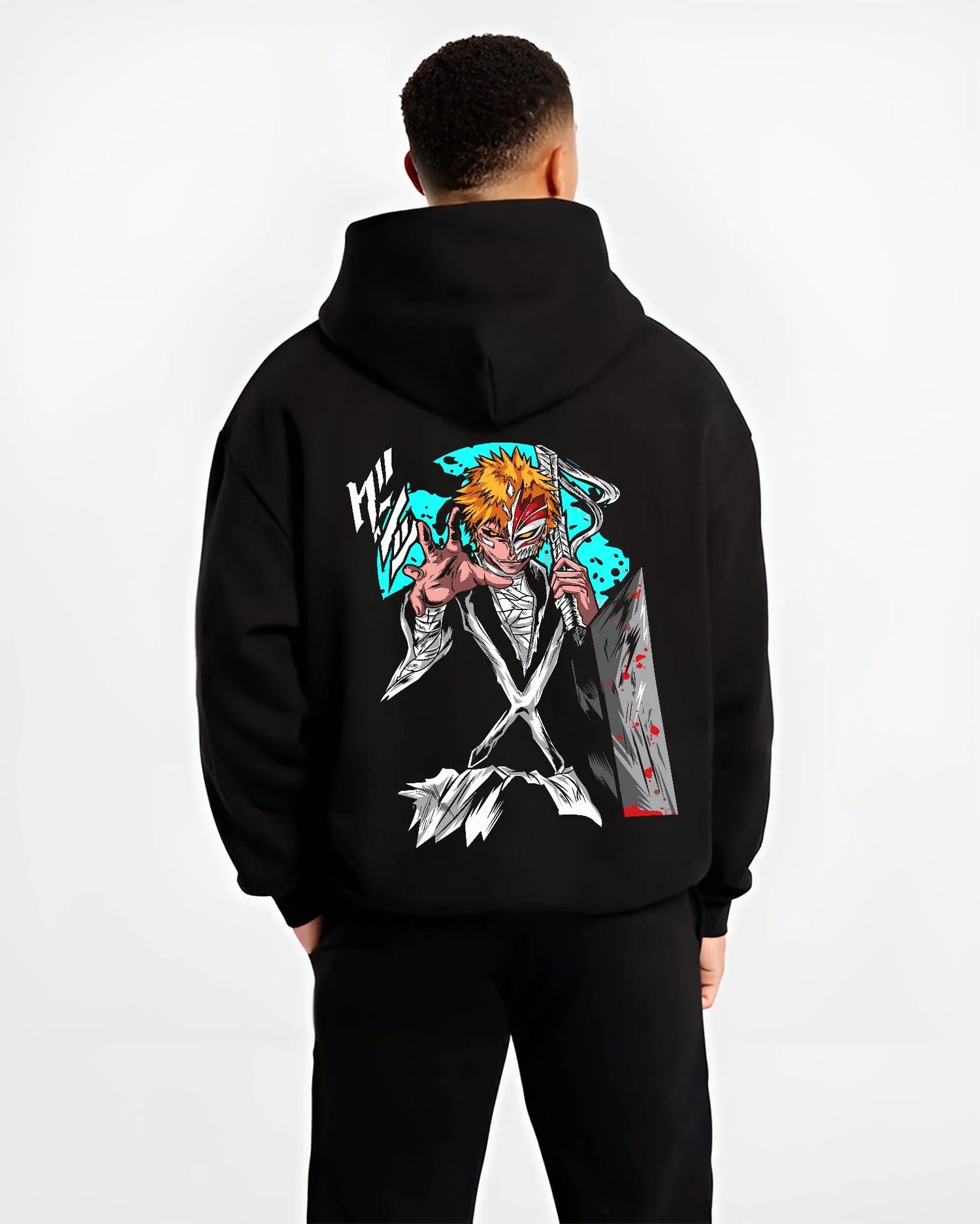 Black hoodie worn by male model, back view with Ichigo Hollow Mask Hoodie Bleach Anime Warrior Jumper graphic bold anime graphic.