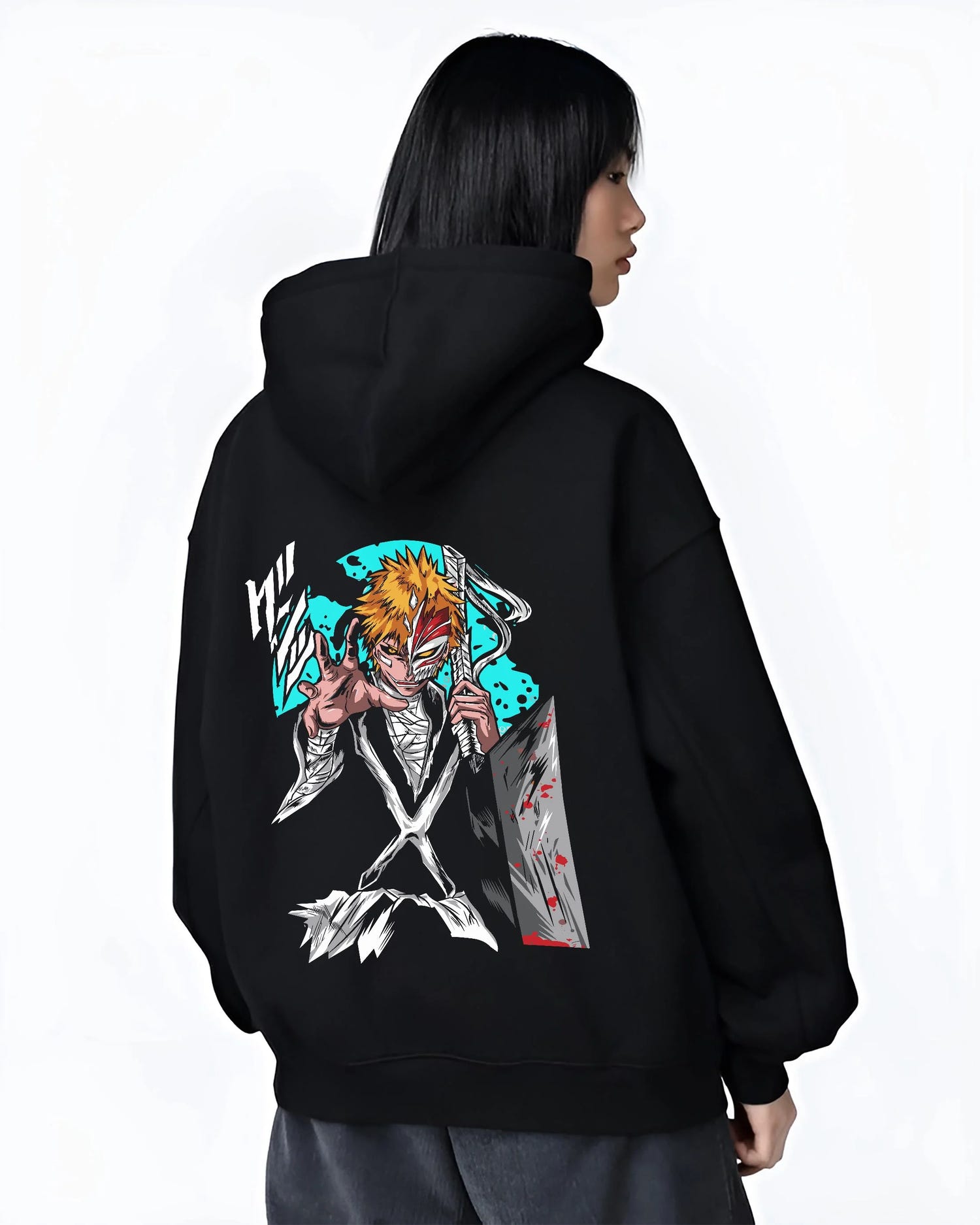 Black hoodie worn by female model, back view with Ichigo Hollow Mask Hoodie Bleach Anime Warrior Jumper graphic bold anime graphic.