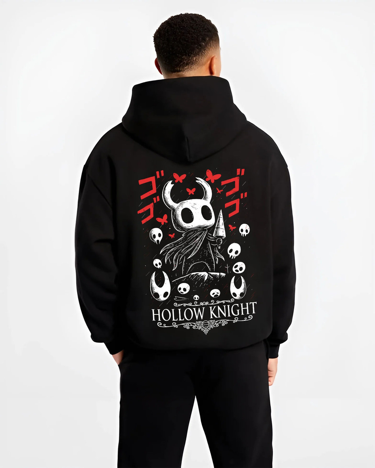Black hoodie model back view showing Hollow Knight: black-and-white knight heads