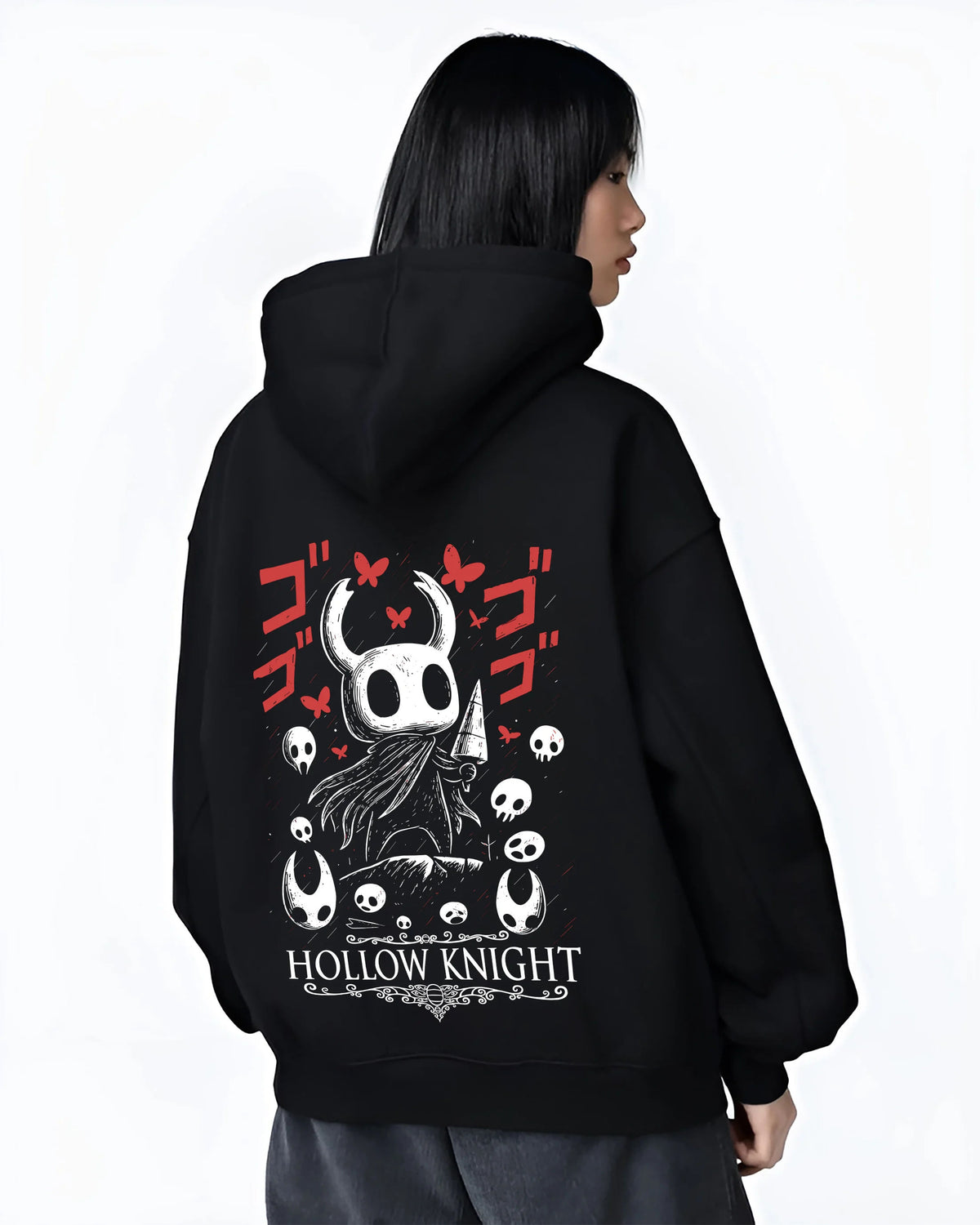 Black hoodie female model back view showing Hollow Knight: black-and-white knight heads