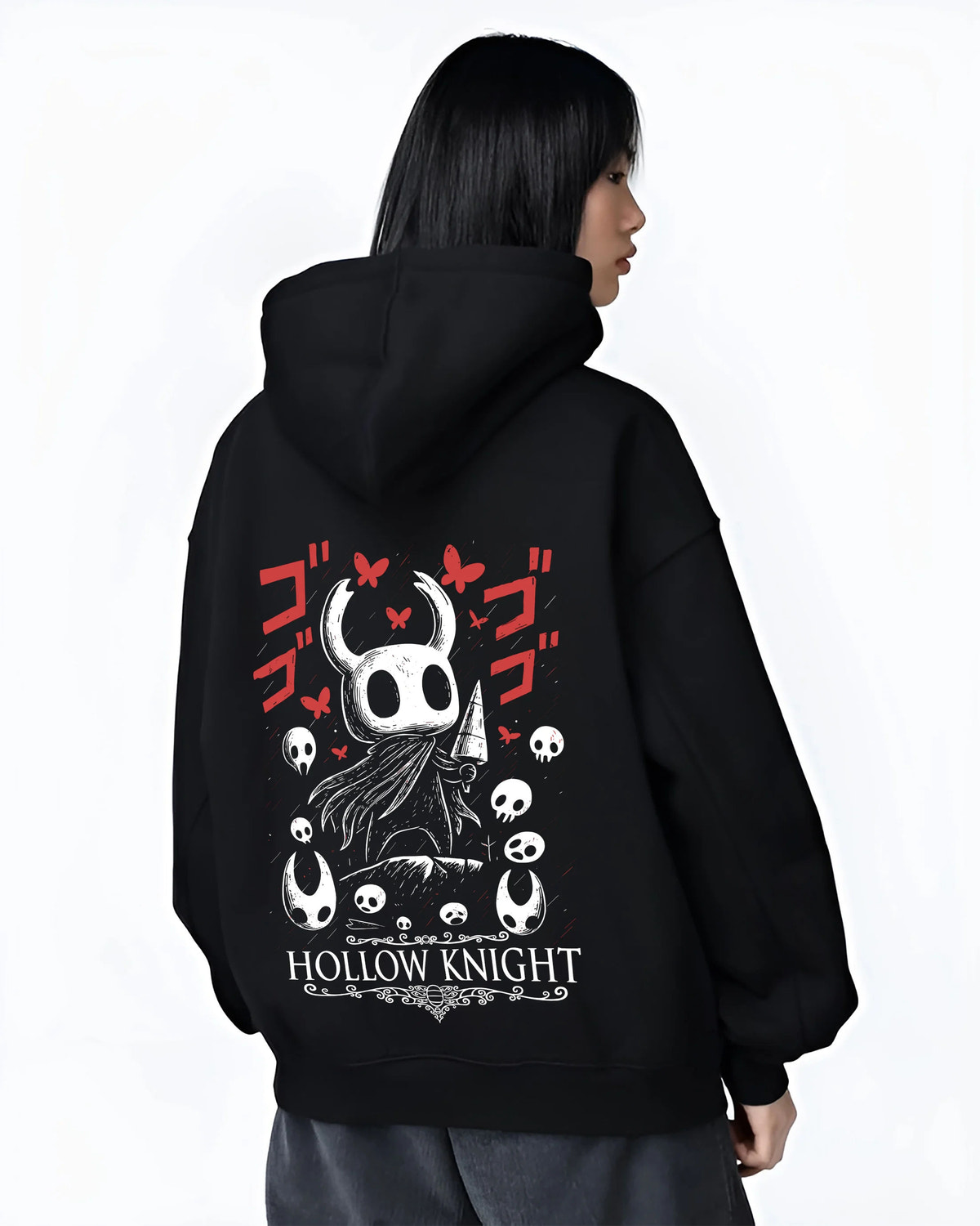 Black hoodie female model back view showing Hollow Knight: black-and-white knight heads