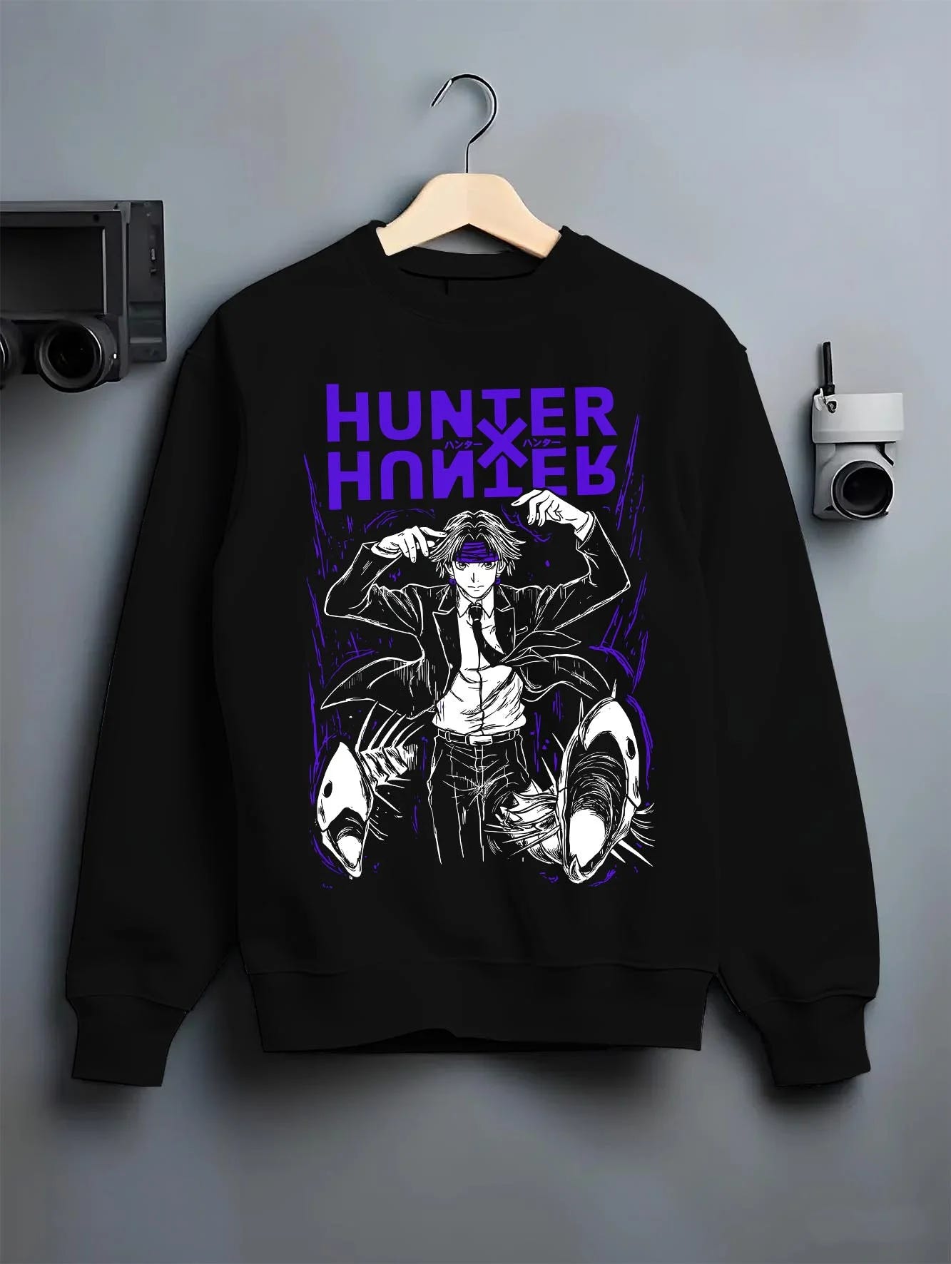 Black crewneck sweatshirt on hanger with Hunter x Hunter Hoodie Logo Classic Retro Jumper graphic bold anime graphic.
