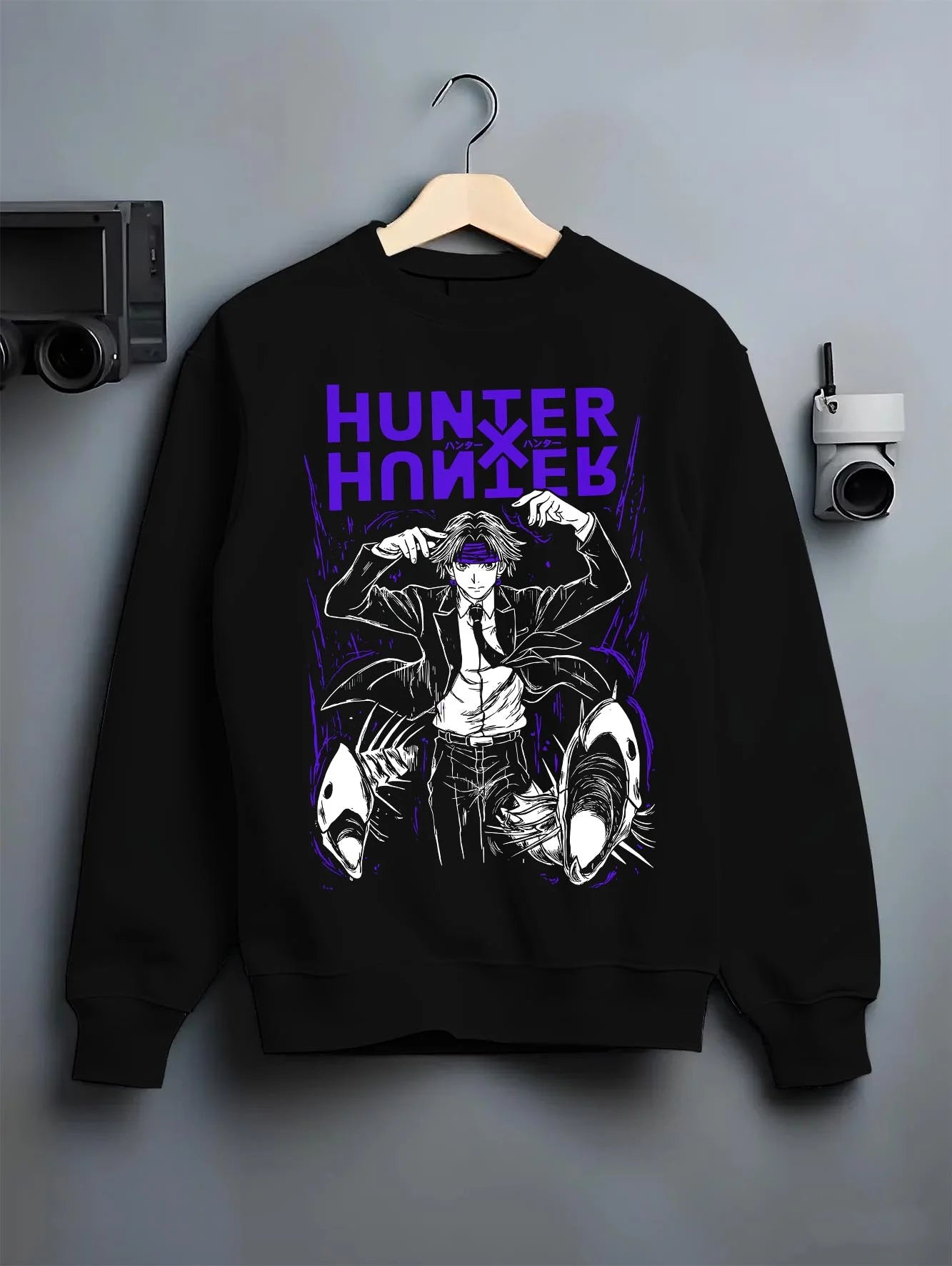 Black crewneck sweatshirt on hanger with Hunter x Hunter Hoodie Logo Classic Retro Jumper graphic bold anime graphic.