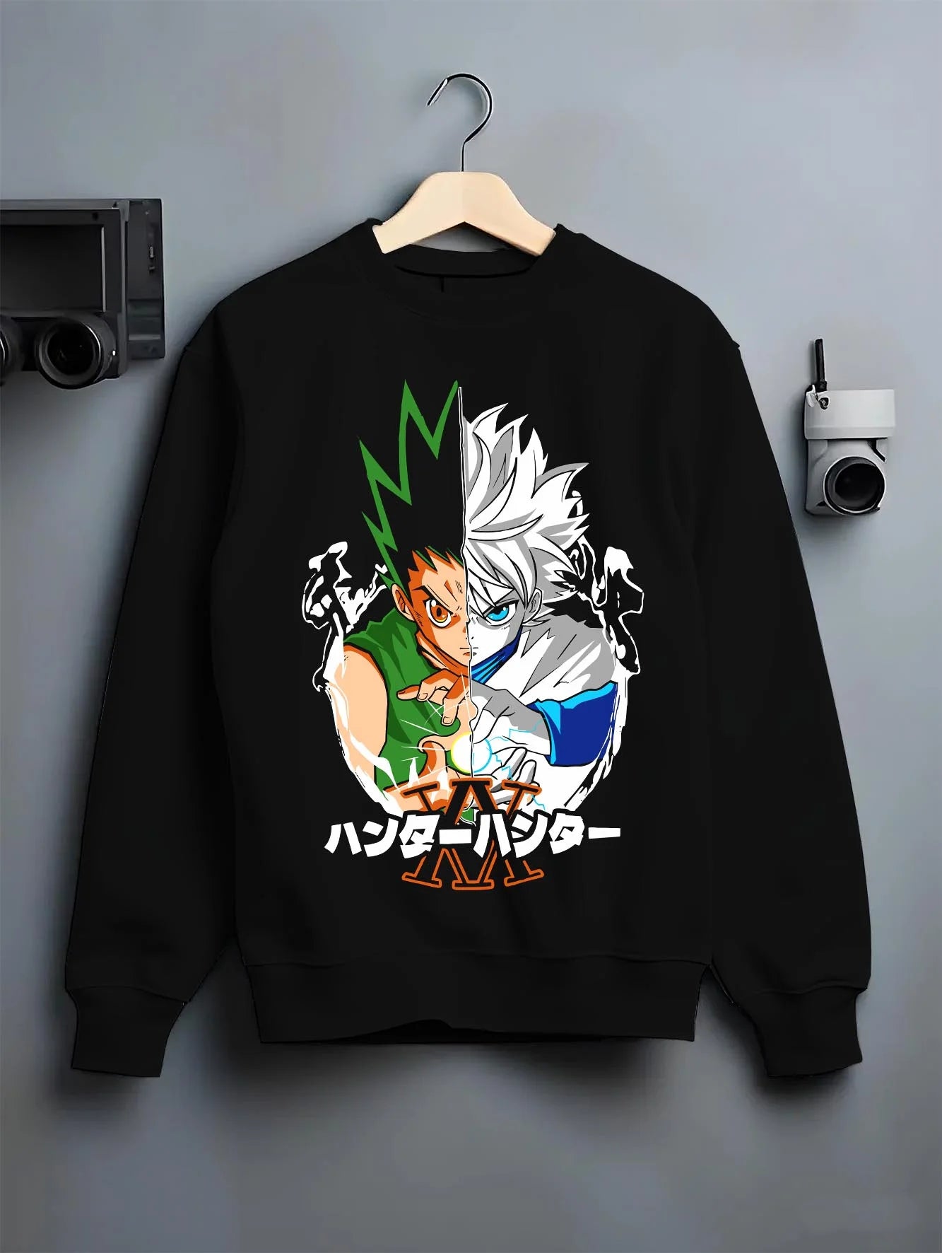 Black crewneck sweatshirt on hanger with Hunter x Hunter Hoodie Gon Killua Team Jumper graphic bold anime graphic.
