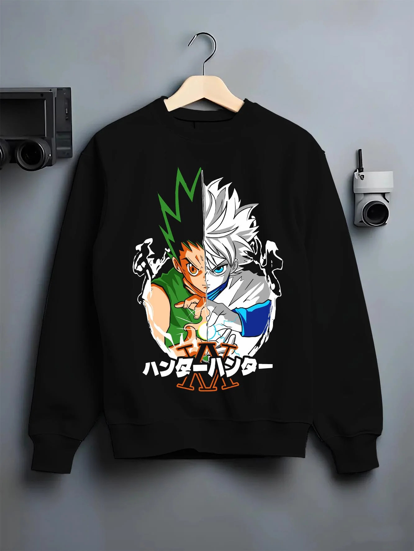 Black crewneck sweatshirt on hanger with Hunter x Hunter Hoodie Gon Killua Team Jumper graphic bold anime graphic.