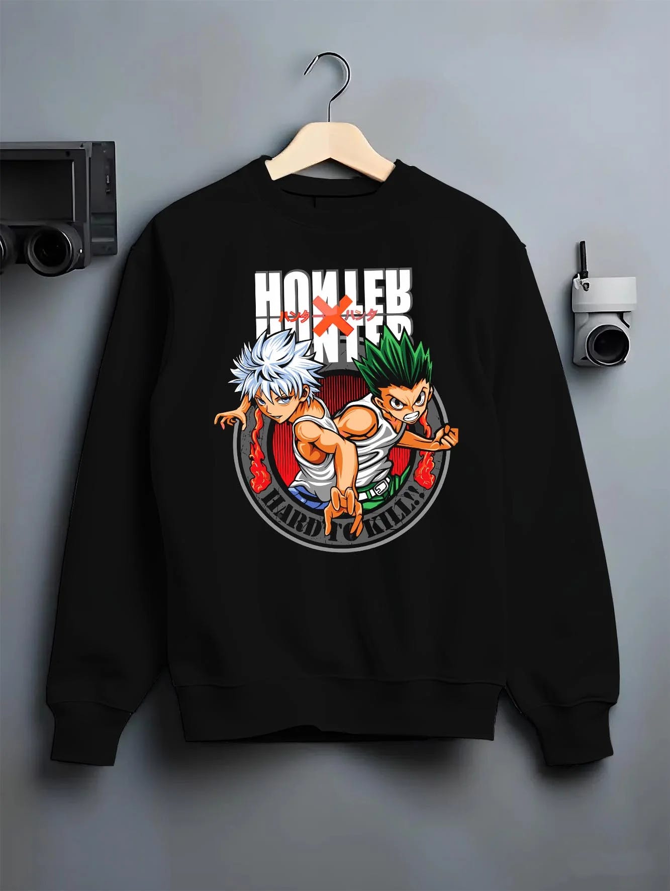 Black crewneck sweatshirt on hanger with Hunter x Hunter Hoodie Yorknew City Arc Jumper graphic bold anime graphic.