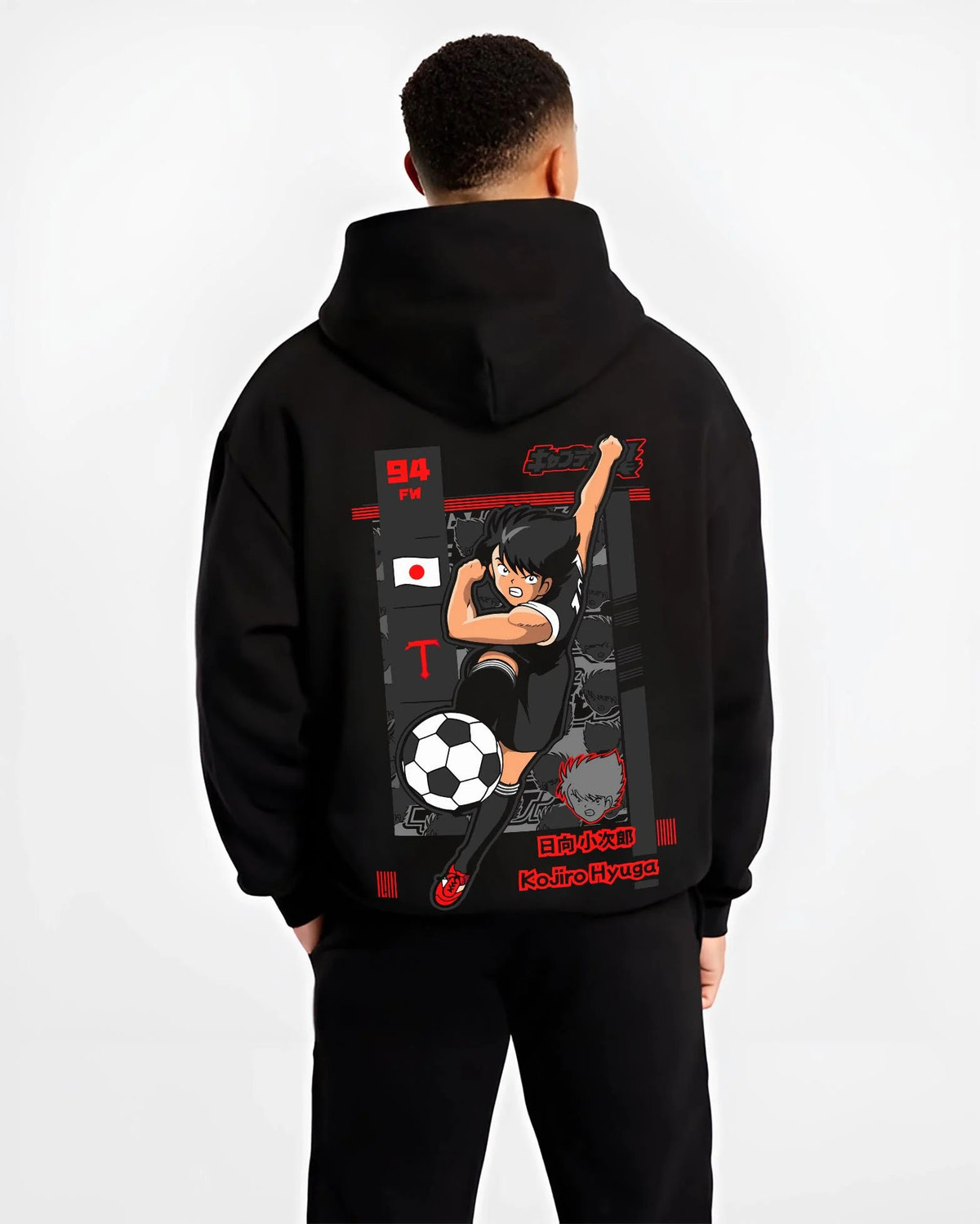 Black hoodie worn by male model from the back featuring Kojiro Hyuga Tiger Shot football artwork.