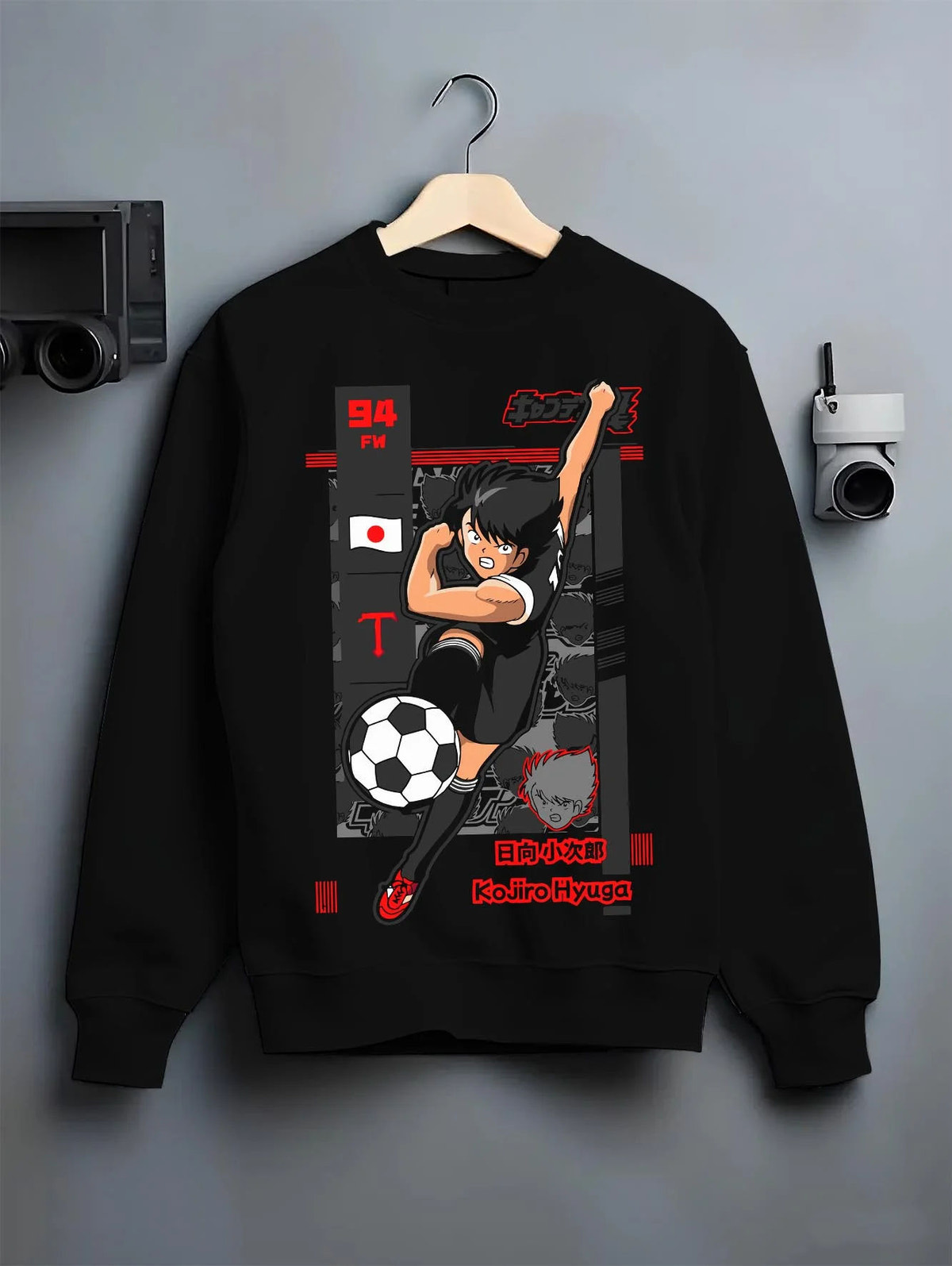 Black crewneck sweatshirt on hanger featuring Kojiro Hyuga Tiger Shot football artwork.