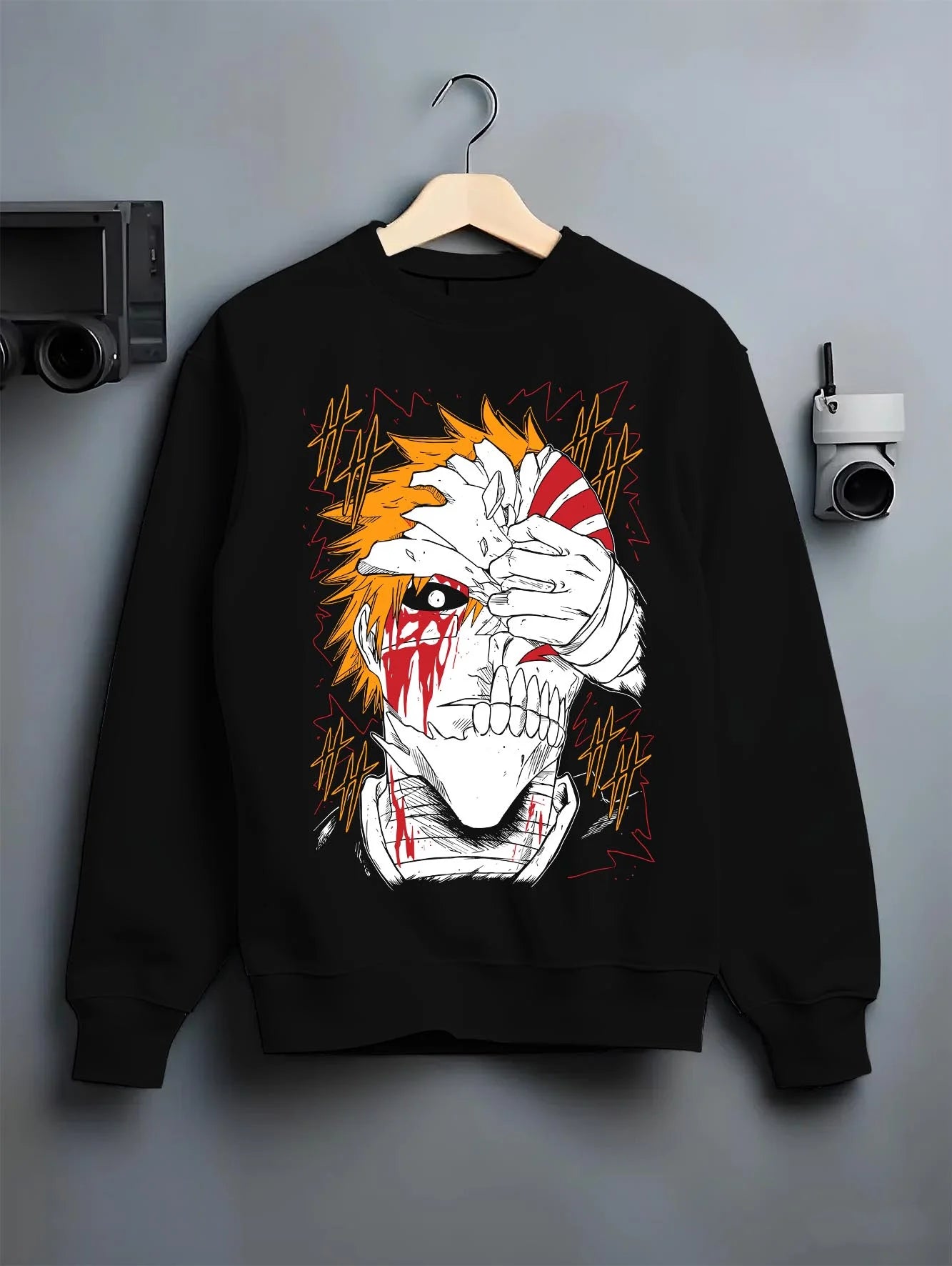 Black crewneck sweatshirt on hanger with Bleach Hoodie Ichigo Kurosaki Hollow Mask Jumper graphic bold anime graphic.