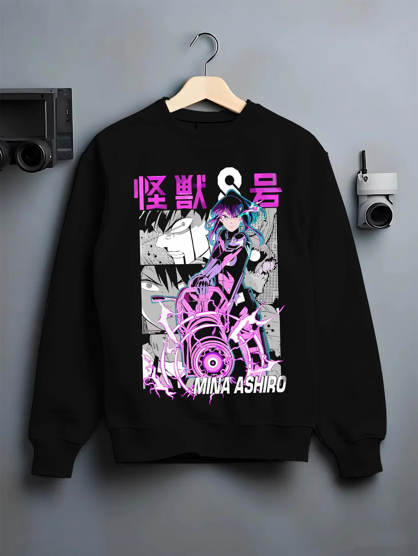 Black crewneck sweatshirt on hanger with Kaiju No. 8 Hoodie Mina Ashiro Defence Squad Jumper graphic bold anime graphic.