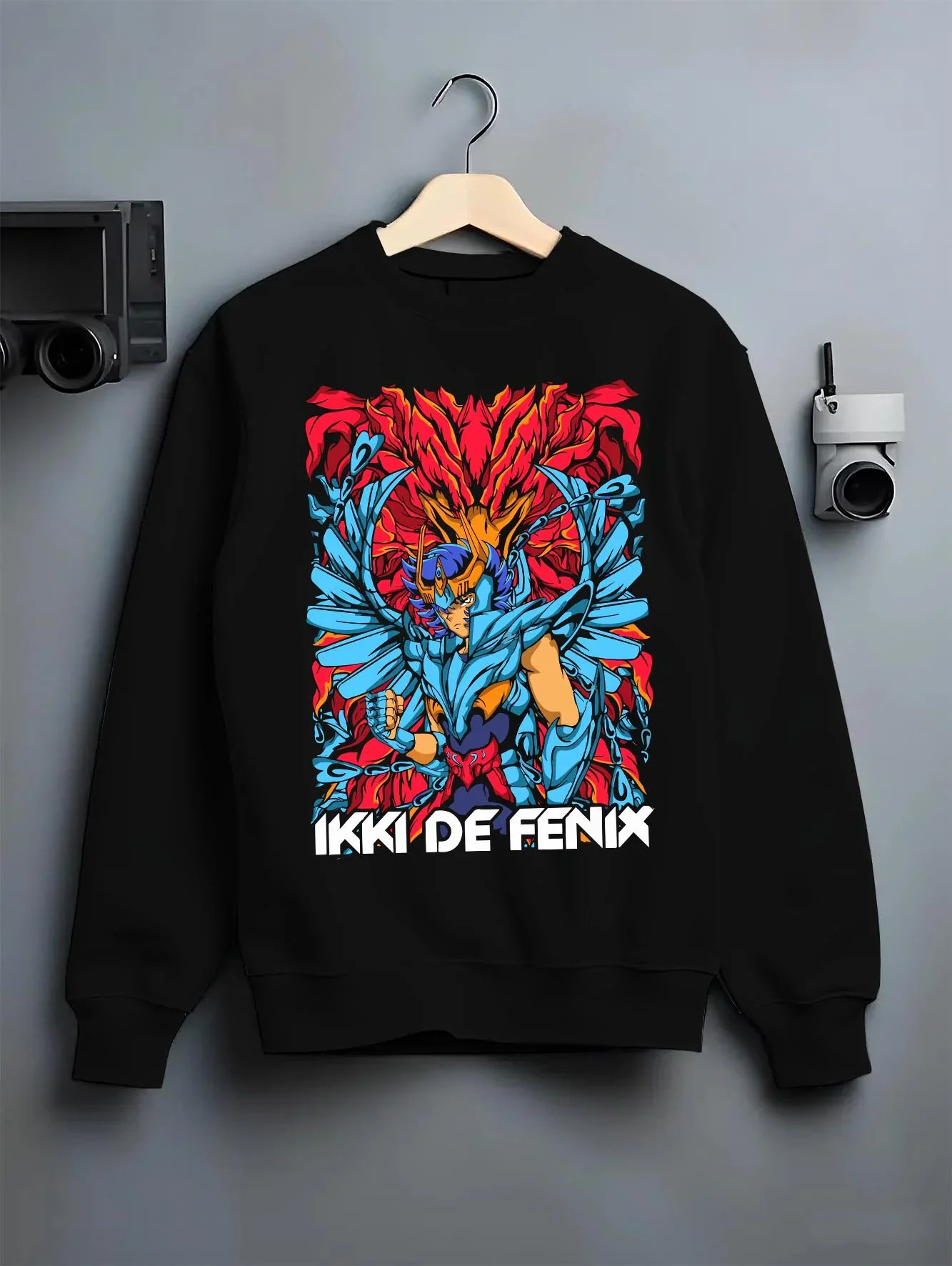 Black crewneck sweatshirt on hanger with Saint Seiya Hoodie Ikki Phoenix Rising Flames Jumper graphic Ikki anime design.