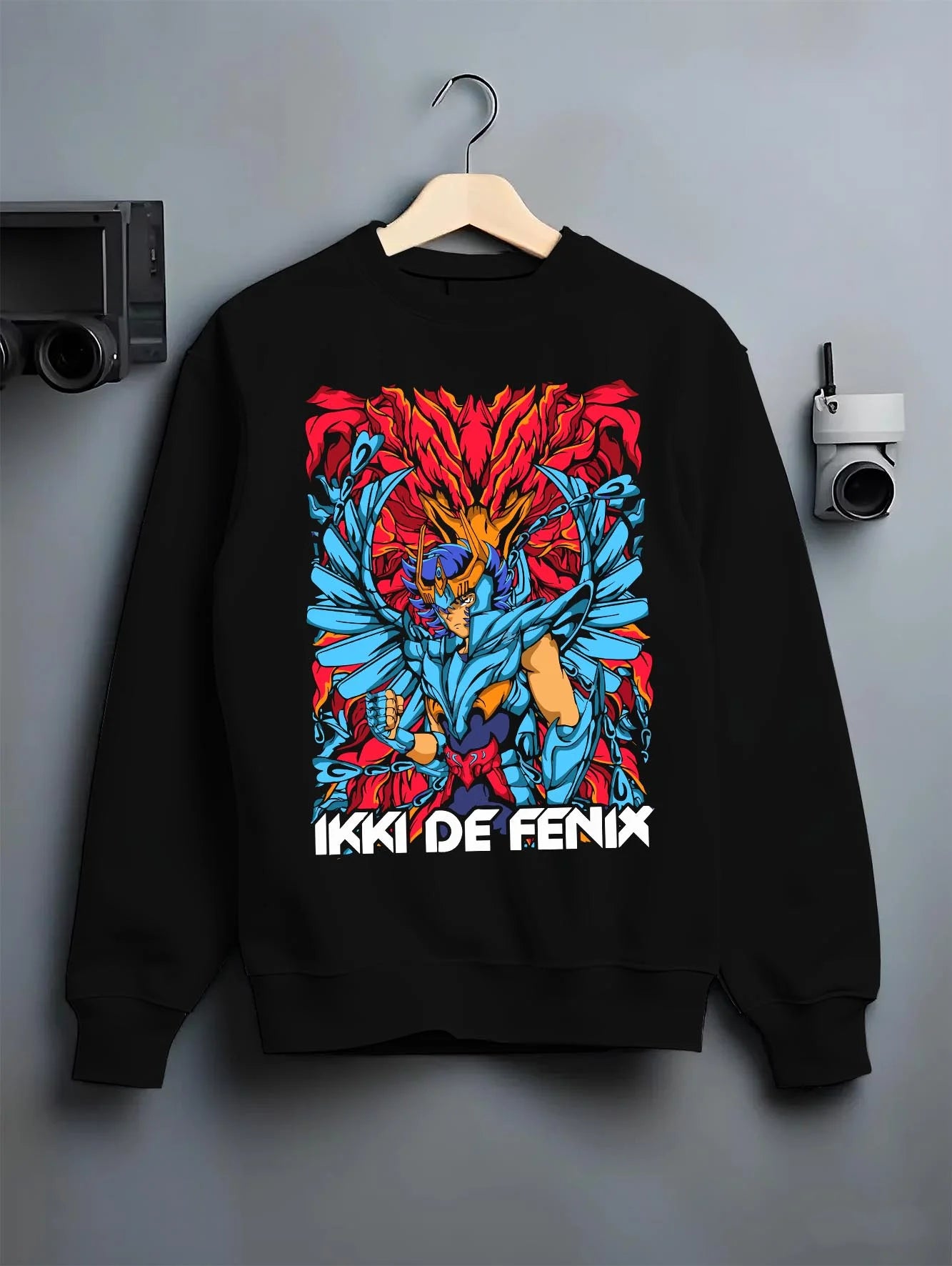 Black crewneck sweatshirt on hanger with Saint Seiya Hoodie Ikki Phoenix Rising Flames Jumper graphic Ikki anime design.