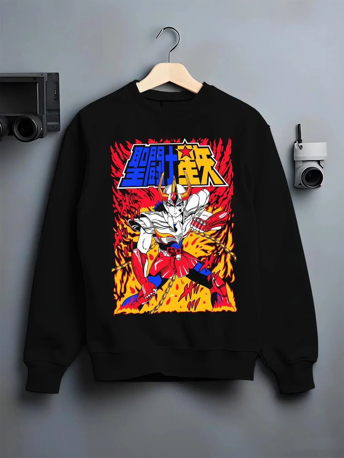 Black crewneck sweatshirt on hanger with Saint Seiya Hoodie Ikki Phoenix Legendary Jumper graphic bold anime graphic.