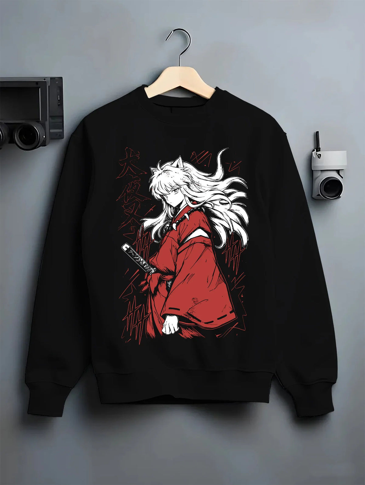 Black crewneck sweatshirt on hanger showing Inuyasha: white-haired swordsman in red robe