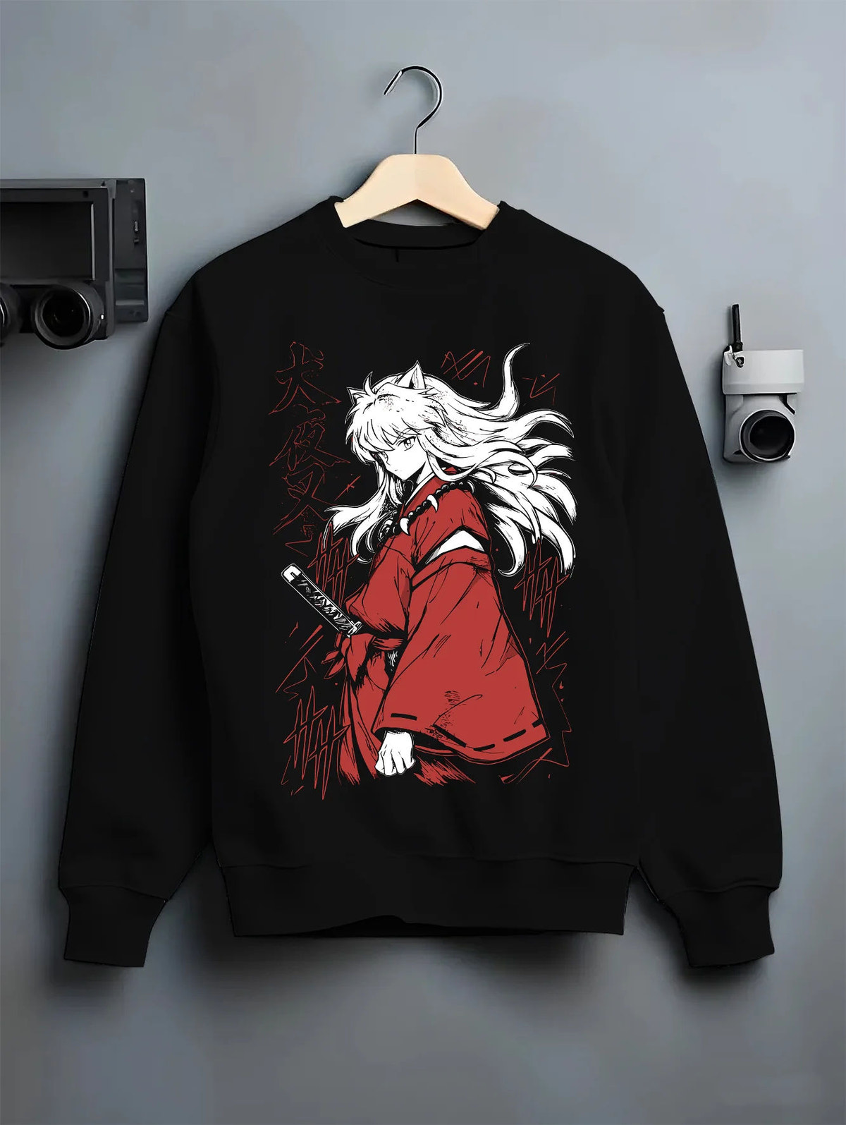 Black crewneck sweatshirt on hanger showing Inuyasha: white-haired swordsman in red robe