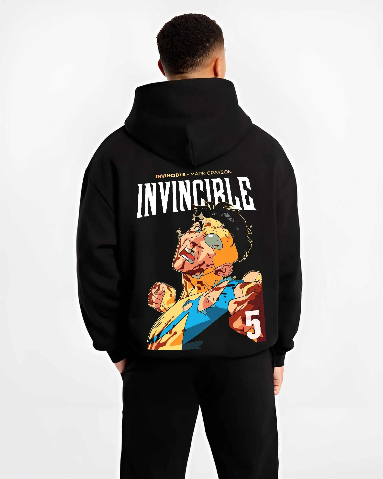 Black hoodie worn by male model, back view with Invincible Hoodie Mark Grayson Battle Damage Jumper graphic streetwear graphic.