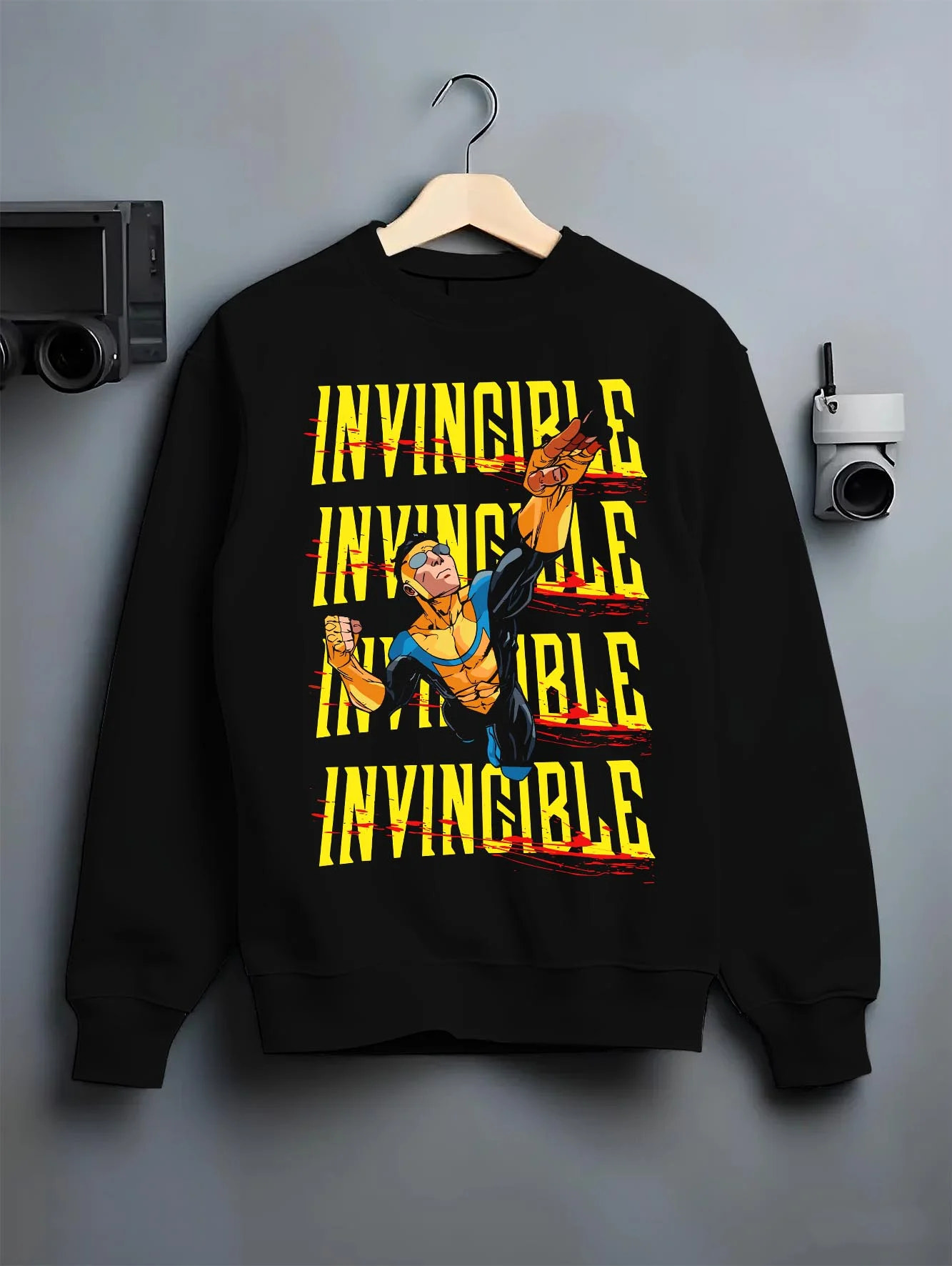 Black crewneck sweatshirt on hanger with Invincible Hoodie Mark Grayson Ultimate Strength Jumper graphic premium wear.
