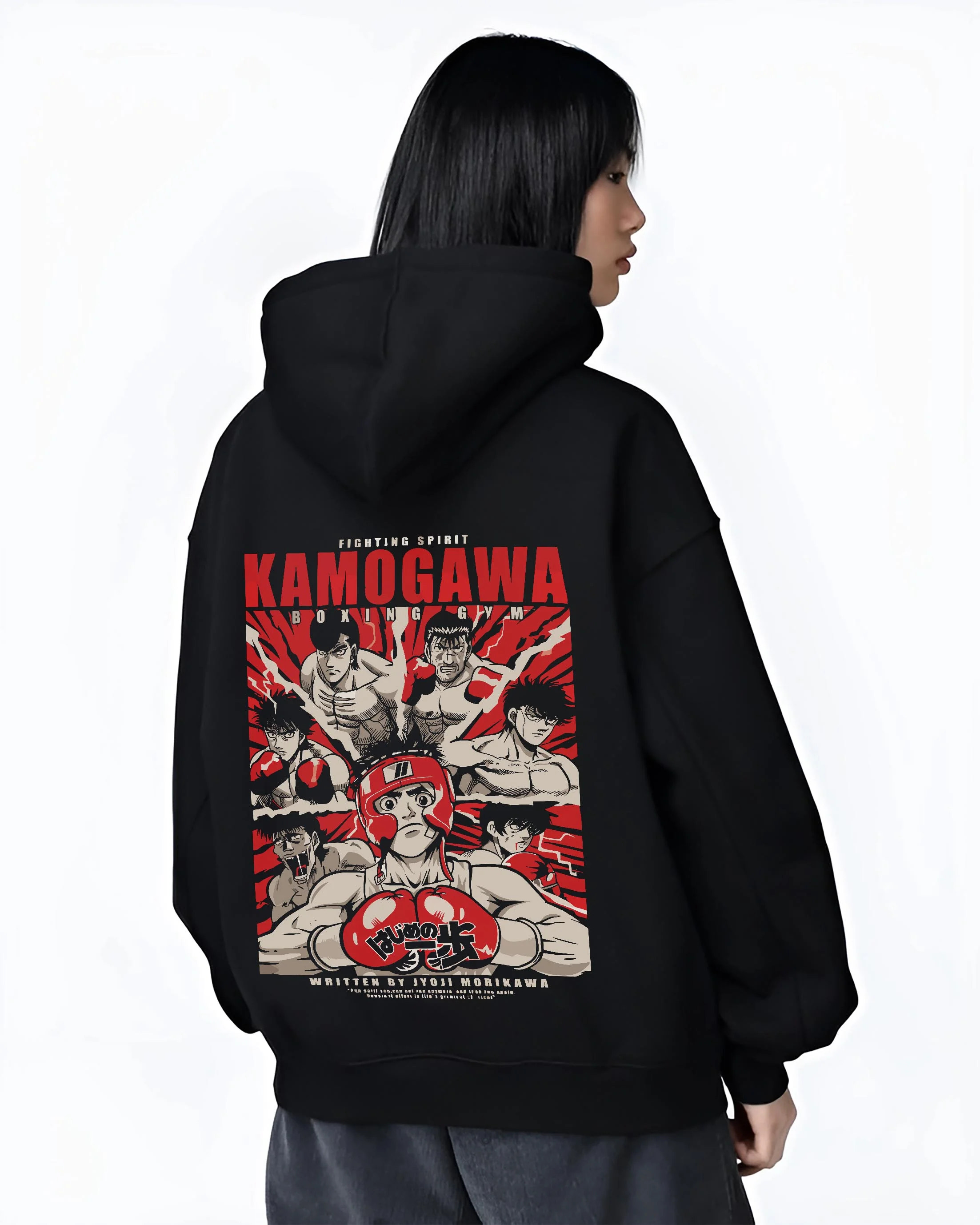 Black hoodie worn by female model, back view with Hajime no Ippo Hoodie Kamogawa Gym Boxing Jumper graphic bold anime graphic.