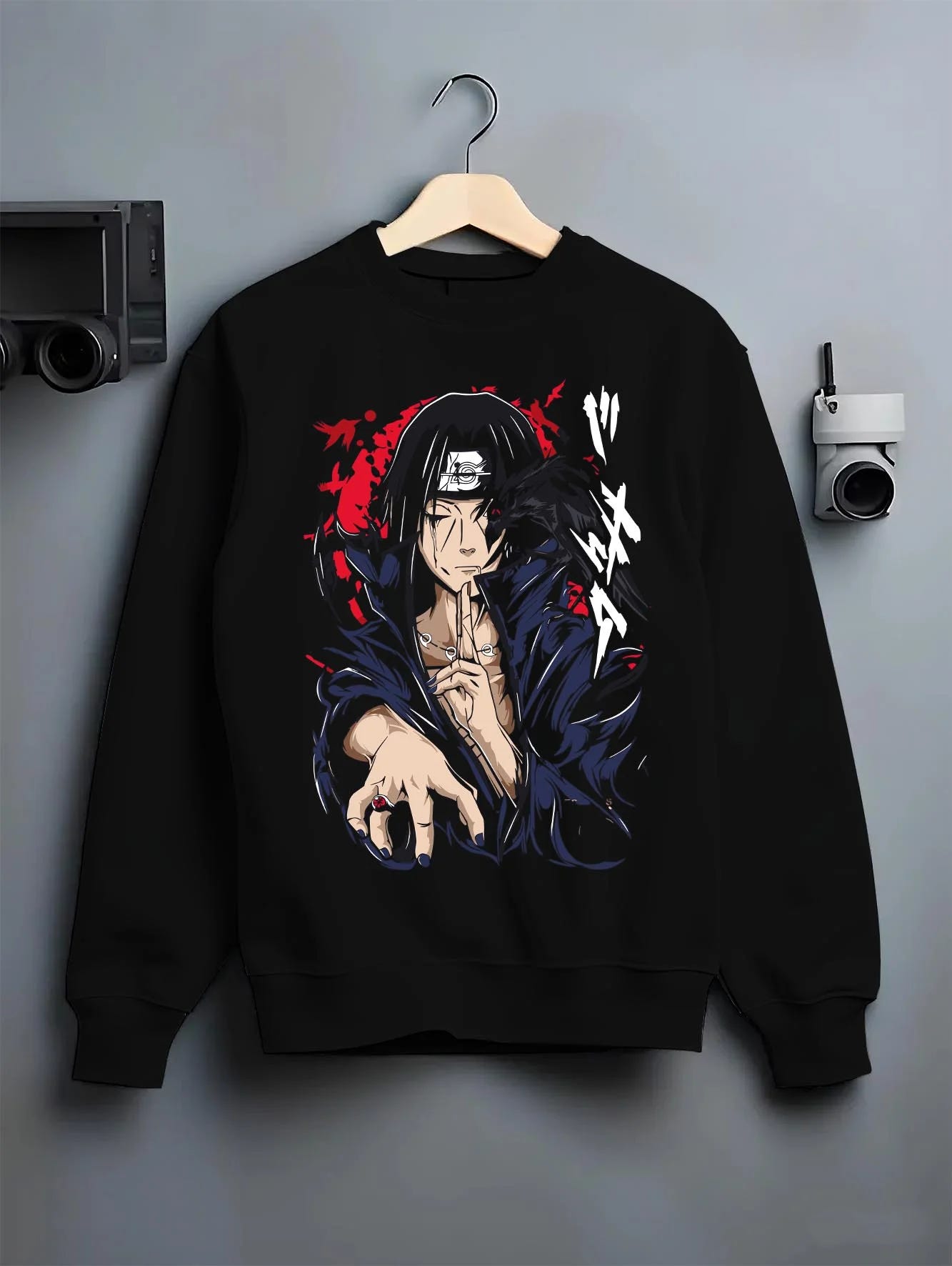 Black crewneck sweatshirt on hanger with Naruto Hoodie Itachi Uchiha Crow Summon Clan Jumper graphic premium wear.