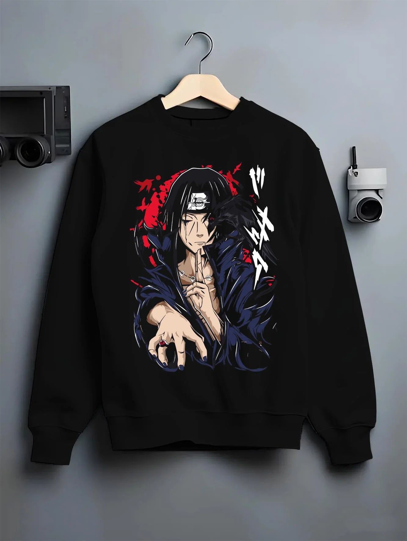 Black crewneck sweatshirt on hanger with Naruto Hoodie Itachi Uchiha Crow Summon Clan Jumper graphic premium wear.