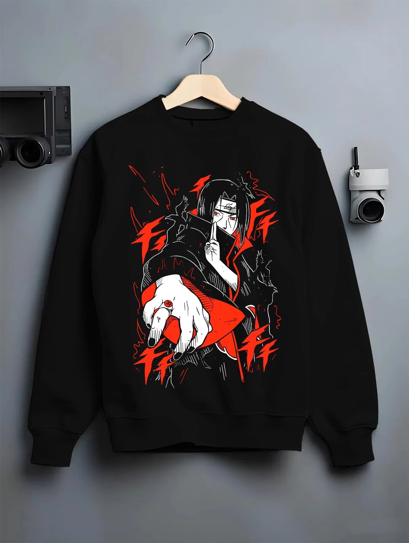 Black crewneck sweatshirt on hanger with Naruto Hoodie Itachi Uchiha Finger Red Moon Jumper graphic bold anime graphic.