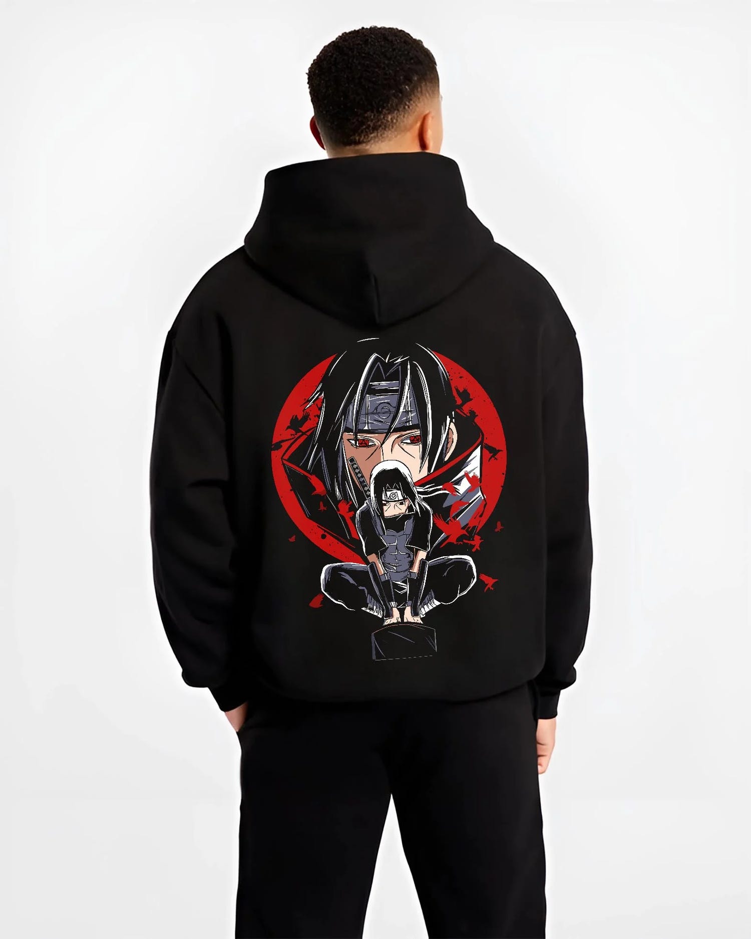 Black hoodie worn by male model, back view with Naruto Hoodie Itachi Uchiha Mangekyo Clan Jumper graphic bold anime graphic.