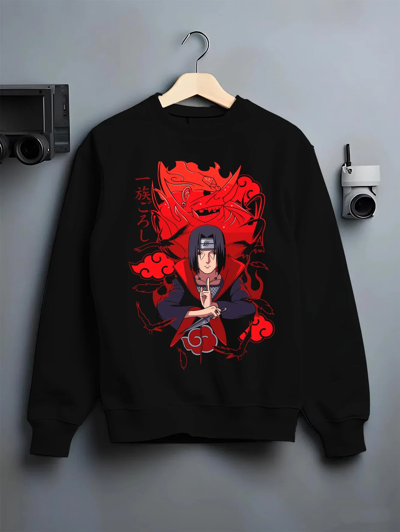 Black crewneck sweatshirt on hanger with Naruto Hoodie Itachi Uchiha Anbu Red Flame Jumper graphic bold anime graphic.