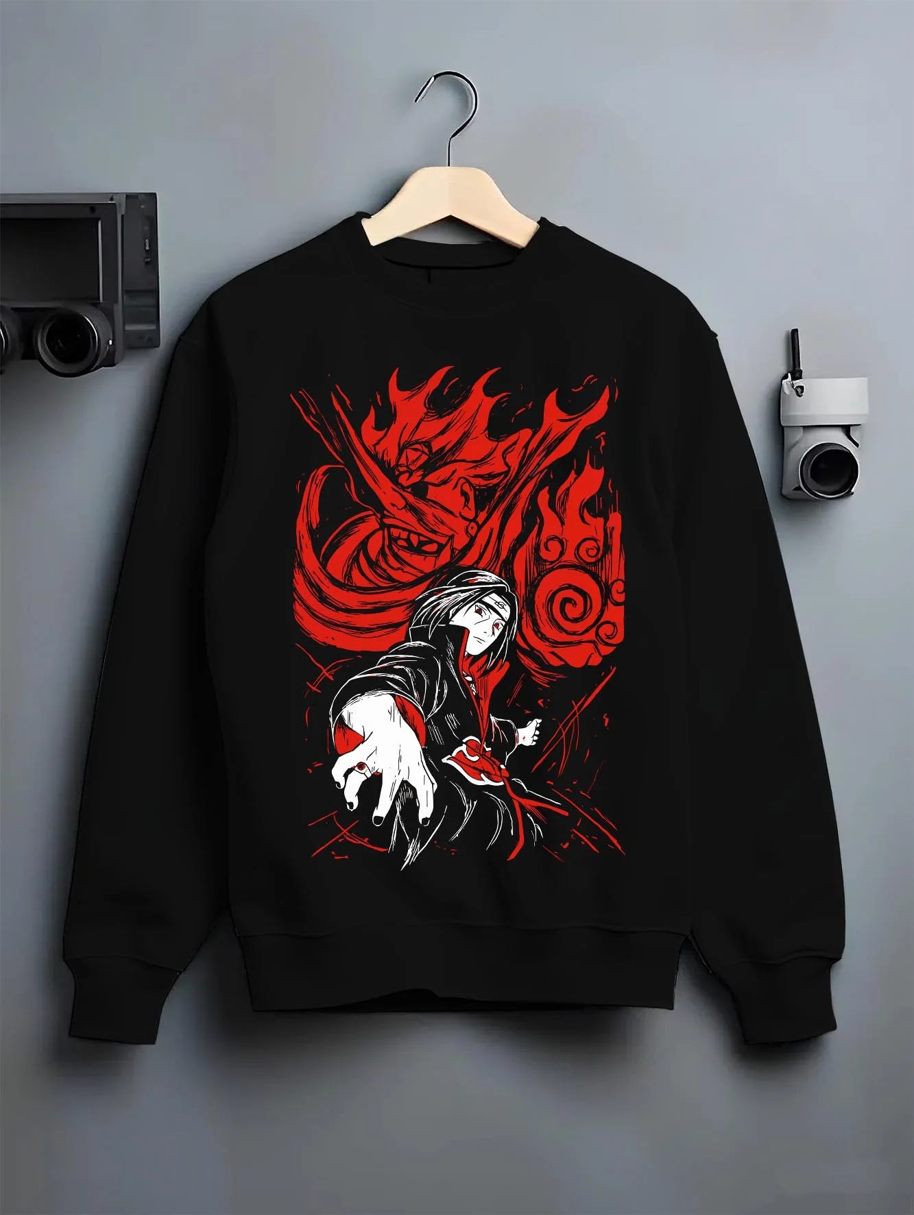 Black crewneck sweatshirt on hanger with Naruto Hoodie Itachi Uchiha Sharingan Power Jumper graphic streetwear graphic.