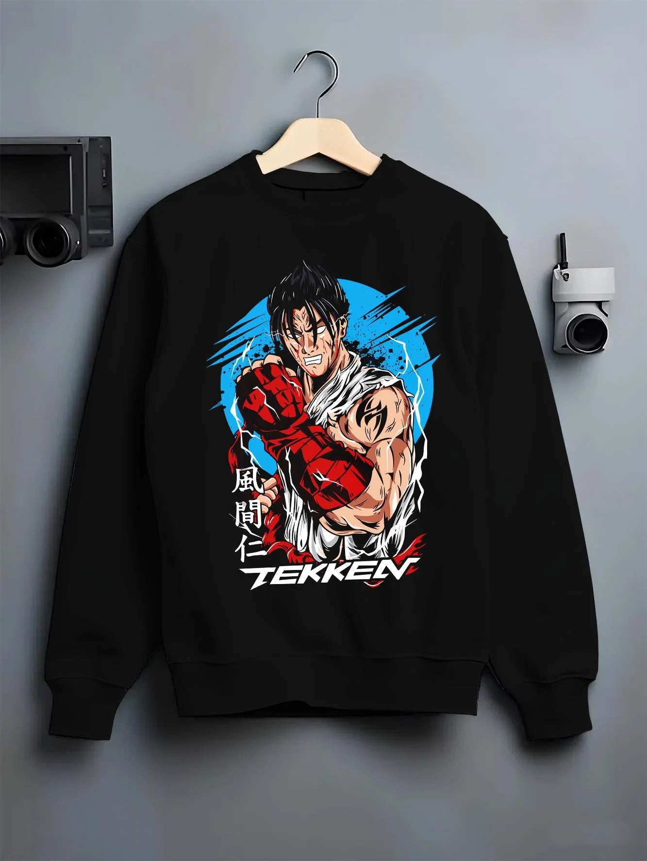 Black crewneck sweatshirt on hanger with Tekken Hoodie Jin Kazama Iron Fist Champion Jumper graphic bold anime graphic.