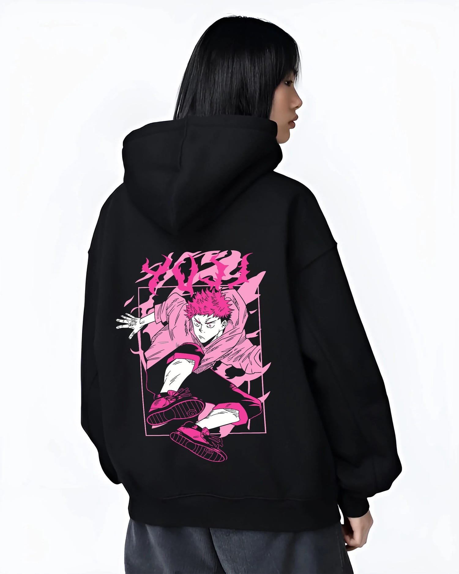Black hoodie worn by female model, back view with Jujutsu Kaisen Hoodie Yuji Itadori Dynamic Jump Jumper graphic bold anime graphic.