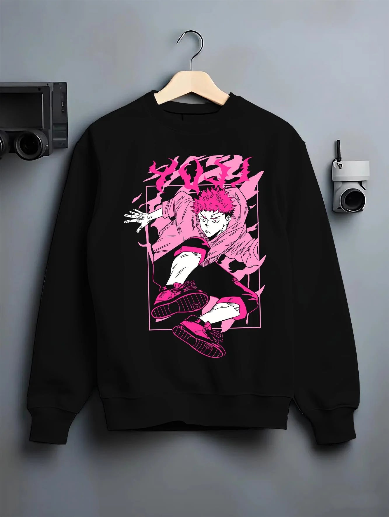 Black crewneck sweatshirt on hanger with Jujutsu Kaisen Hoodie Yuji Itadori Dynamic Jump Jumper graphic bold anime graphic.