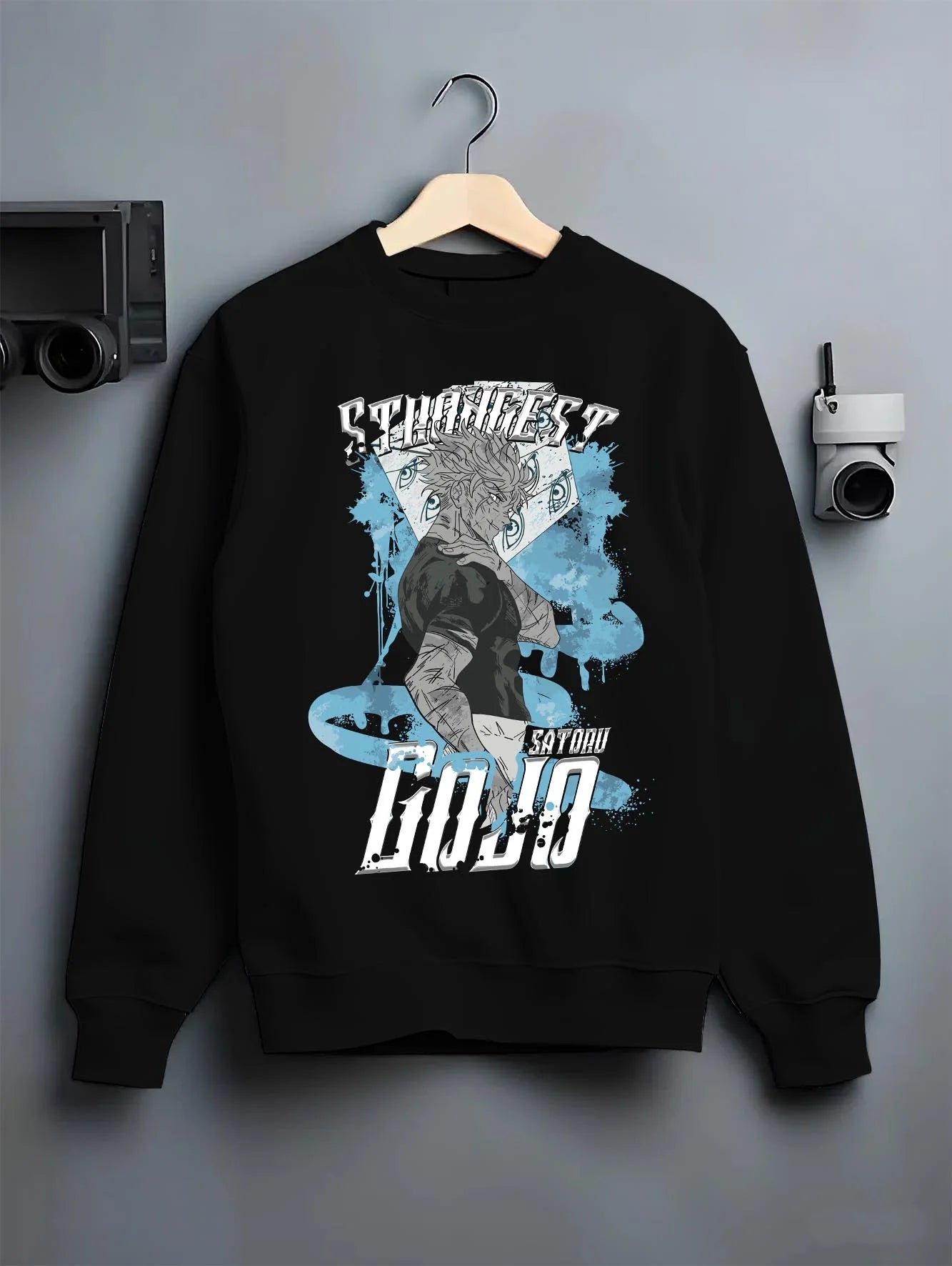 Black crewneck sweatshirt on hanger with Jujutsu Kaisen Hoodie Satoru Gojo Strongest Sorcerer graphic bold anime graphic.
