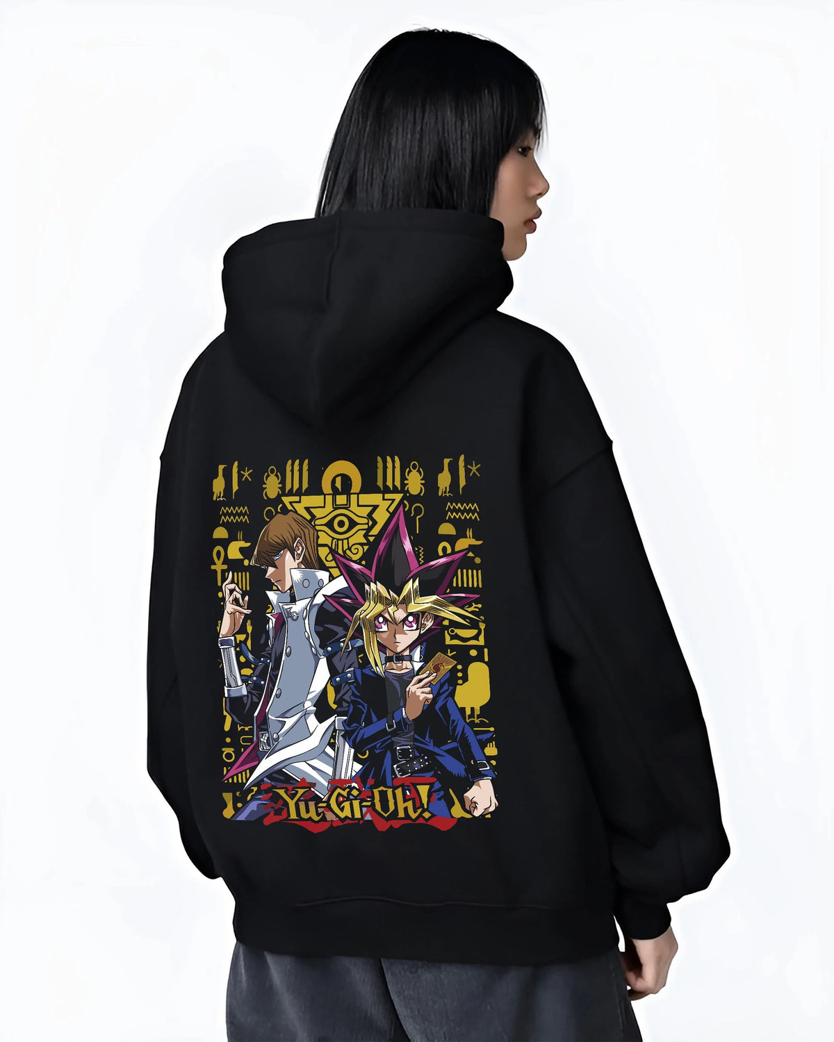 Black hoodie worn by female model from the back featuring Yugi and Kaiba duel rivals artwork.