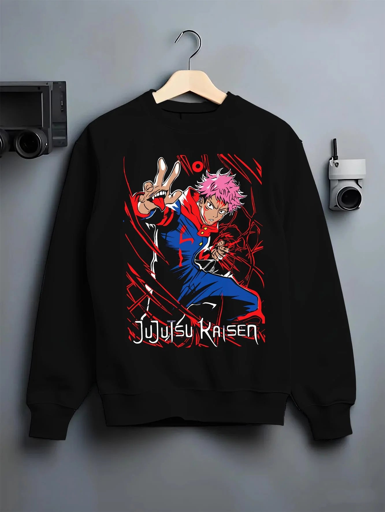 Black crewneck sweatshirt on hanger with Jujutsu Kaisen Hoodie Yuji Itadori Hero Punch Jumper graphic streetwear graphic.