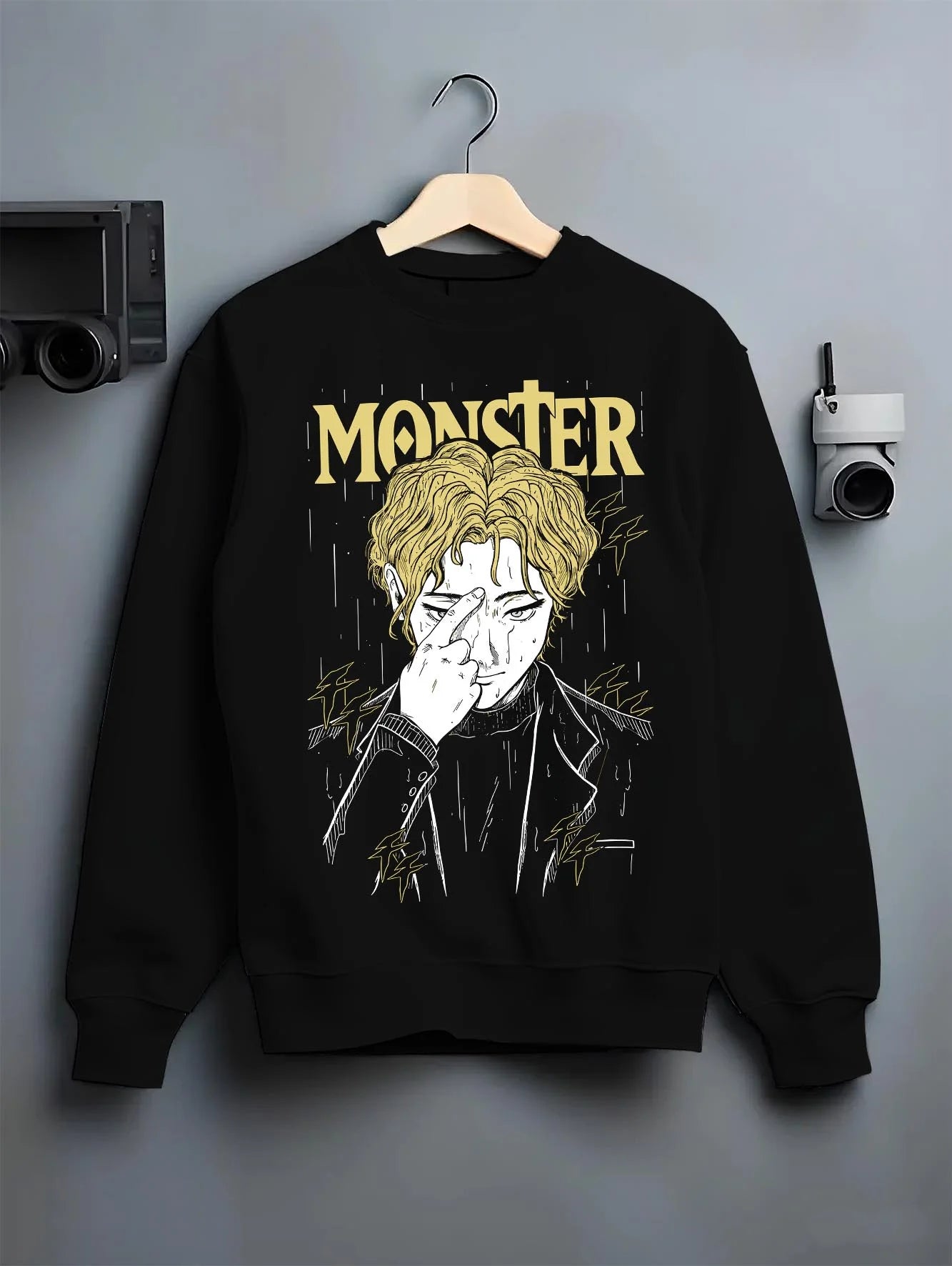 Black crewneck sweatshirt on hanger with Monster Hoodie Johan Liebert Psychological Thriller graphic streetwear graphic.
