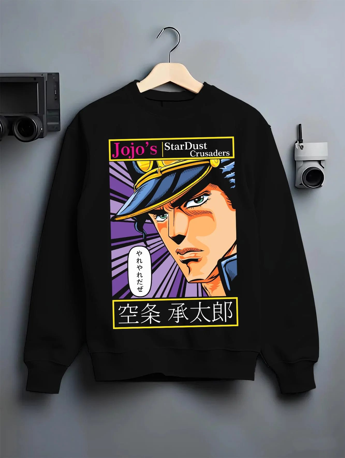 Black crewneck sweatshirt on hanger with Jotaro Kujo Hoodie JoJo’s Bizarre Adventure Stardust Arc graphic premium wear.