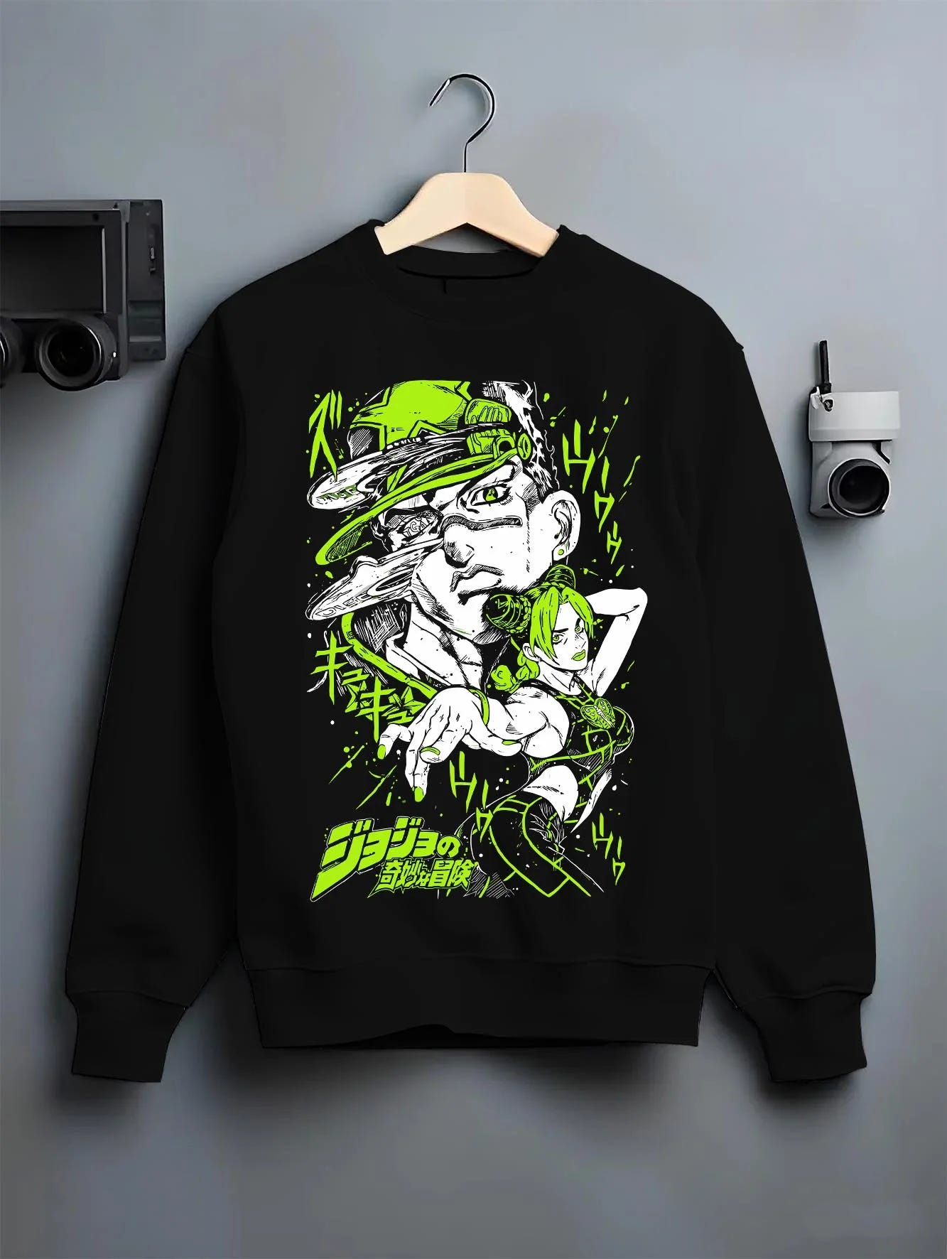 Black crewneck sweatshirt on hanger with Jolyne Cujoh Hoodie JoJo’s Bizarre Adventure Green Dolphin graphic premium wear.