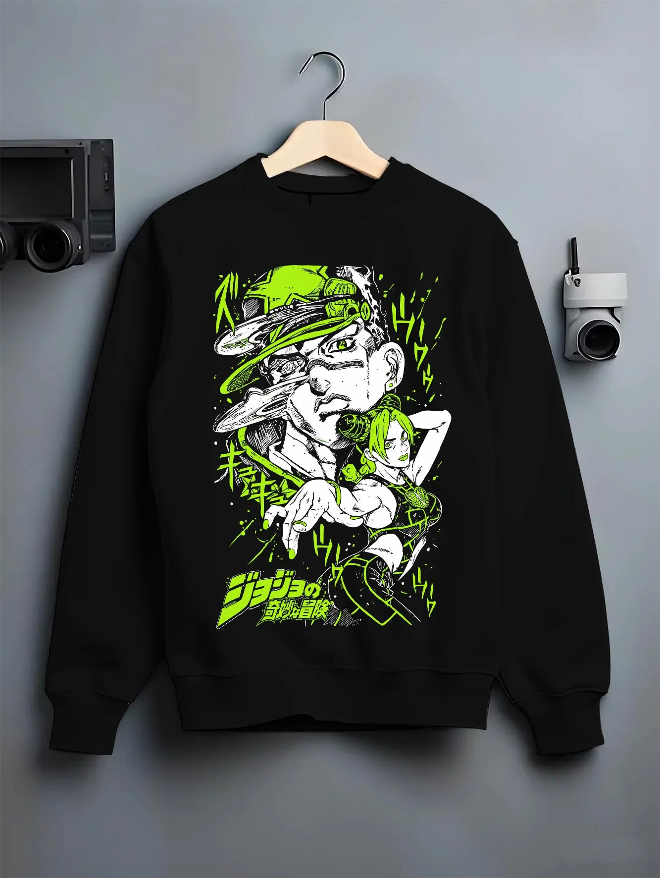 Black crewneck sweatshirt on hanger with Jolyne Cujoh Hoodie JoJo’s Bizarre Adventure Green Dolphin graphic premium wear.