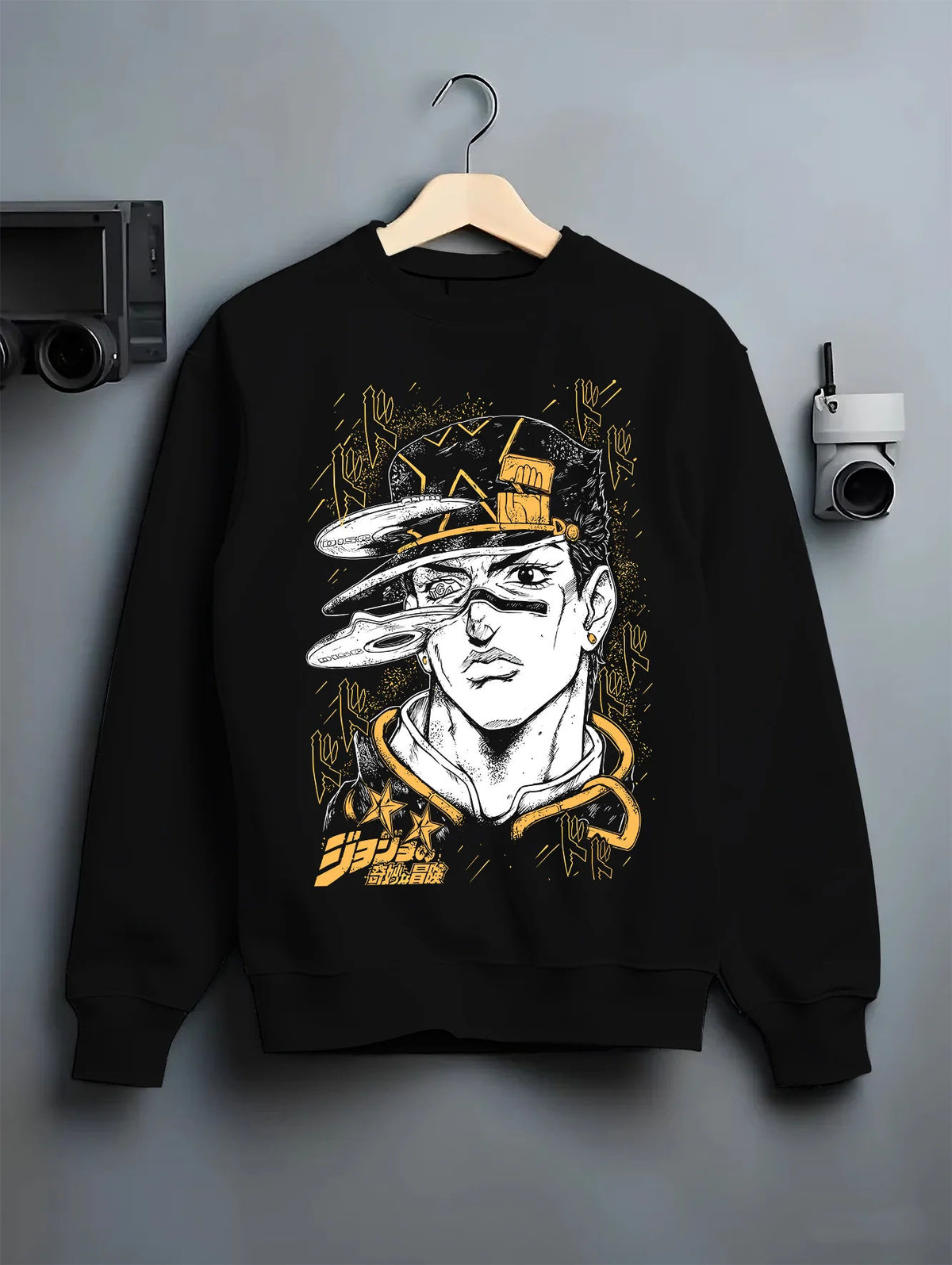 Black crewneck sweatshirt on hanger with Jotaro Kujo portrait with hat and gold background from JoJo’s Bizarre Adventure