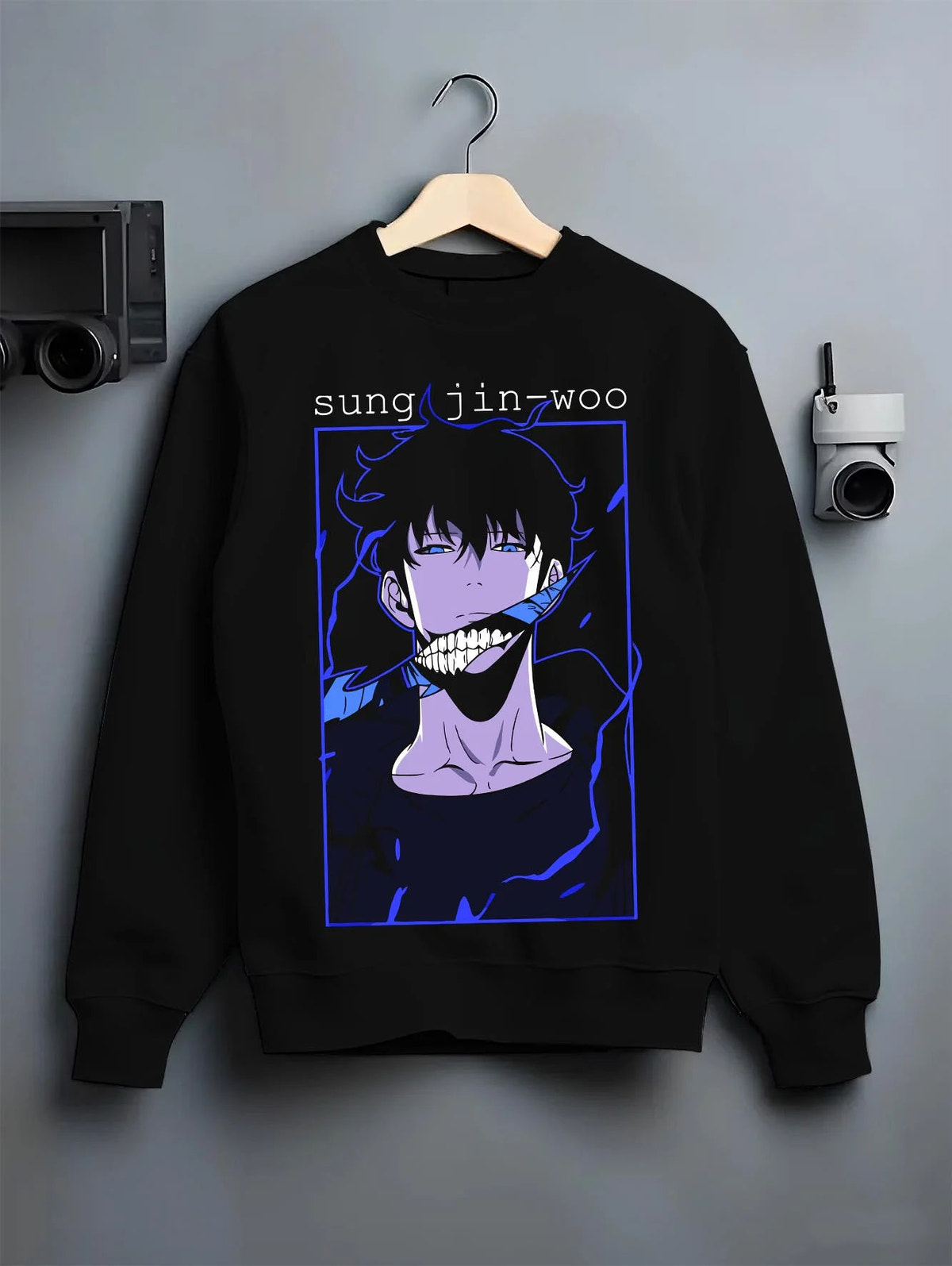 Black crewneck sweatshirt on hanger featuring Sung Jin-Woo blue aura Shadow Monarch artwork.