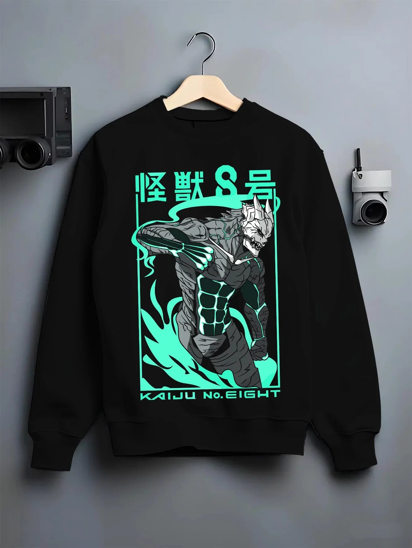 Black crewneck sweatshirt on hanger with Kaiju No. 8 Hoodie Anime Kaiju Monster Fight Design graphic streetwear graphic.