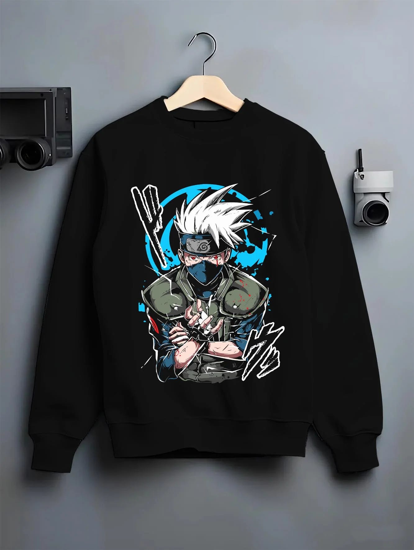 Black crewneck sweatshirt on hanger with Kakashi Hatake Hoodie Naruto Copy Ninja Jonin Leader graphic premium wear.