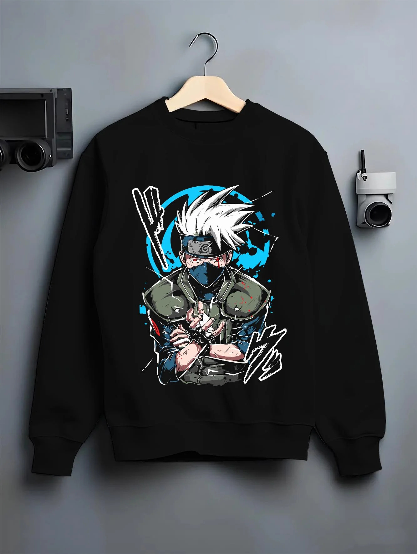 Black crewneck sweatshirt on hanger with Kakashi Hatake Hoodie Naruto Copy Ninja Jonin Leader graphic premium wear.