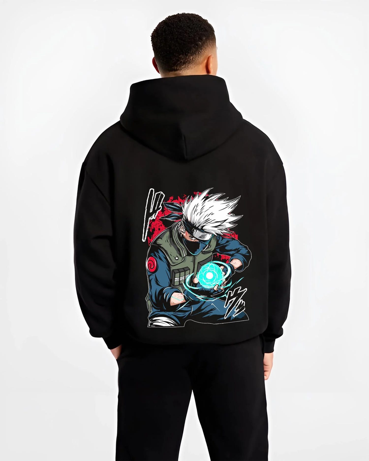 Black hoodie worn by male model, back view with Kakashi Hatake Hoodie Naruto Rasengan Jonin Pose graphic streetwear graphic.