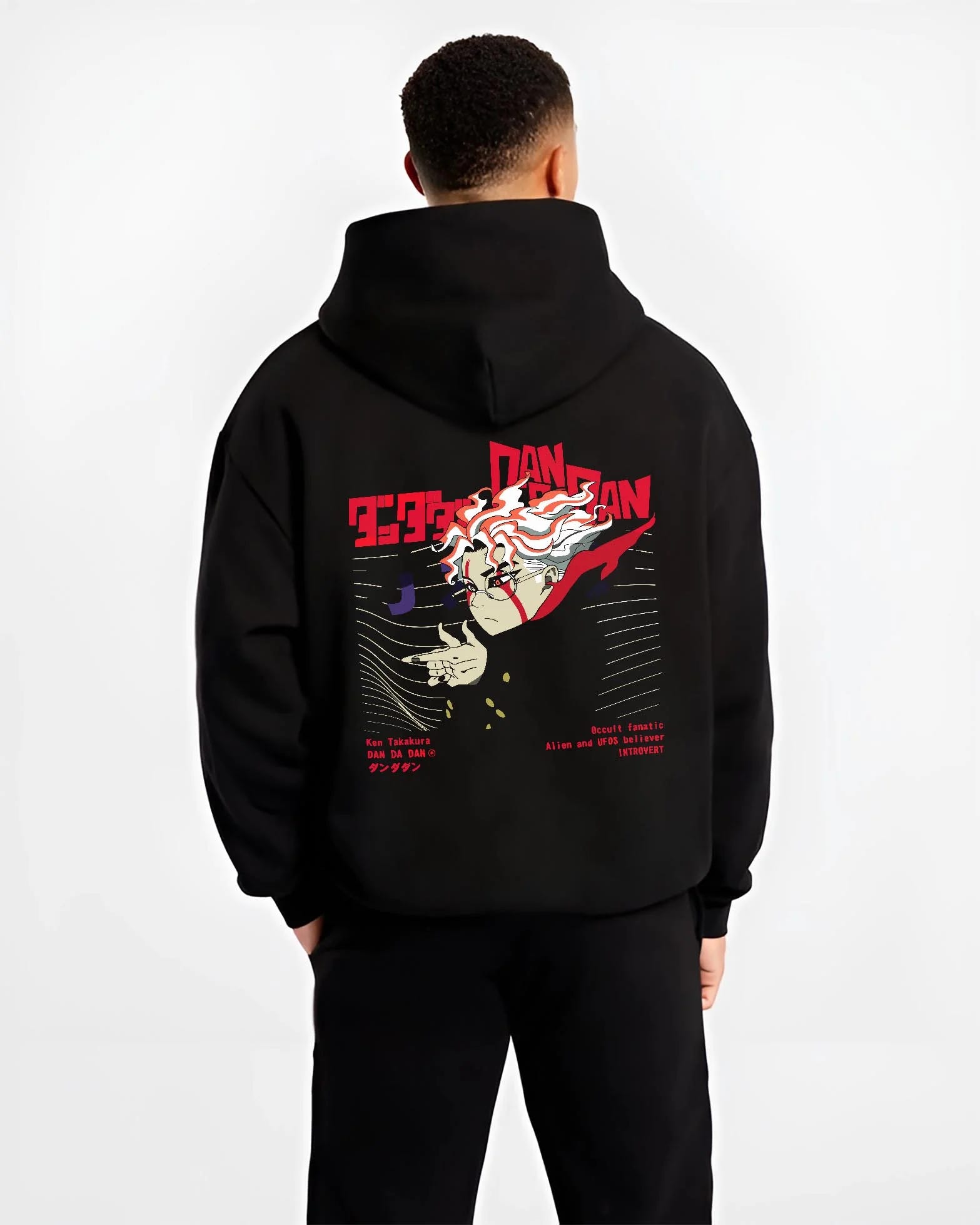 Black hoodie worn by male model, back view with Ken Takakura Dandadan Hoodie Occult UFO Believer Retro graphic streetwear graphic.