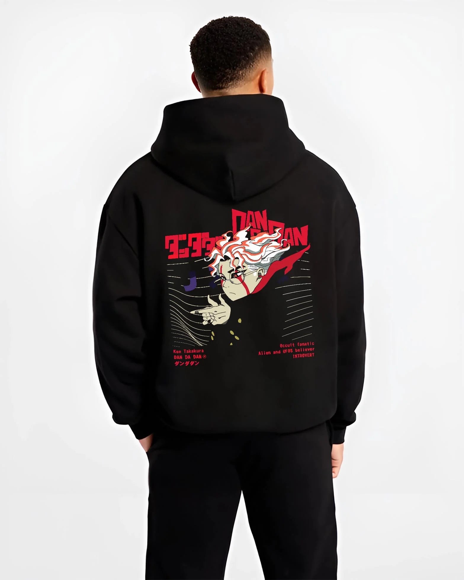 Black hoodie worn by male model, back view with Ken Takakura Dandadan Hoodie Occult UFO Believer Retro graphic streetwear graphic.