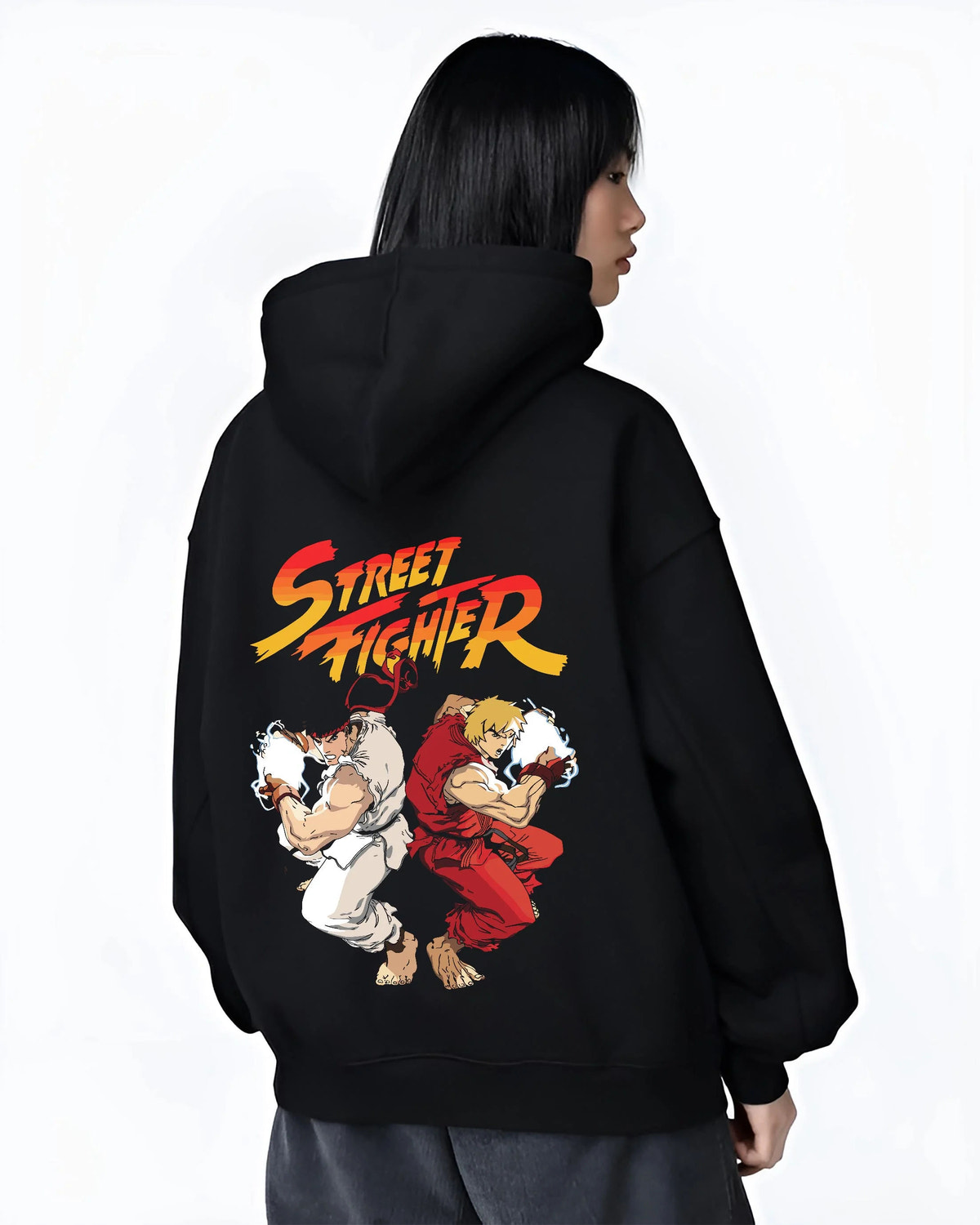 Black hoodie worn by female model from the back featuring Ken Masters and Ryu rival battle artwork.