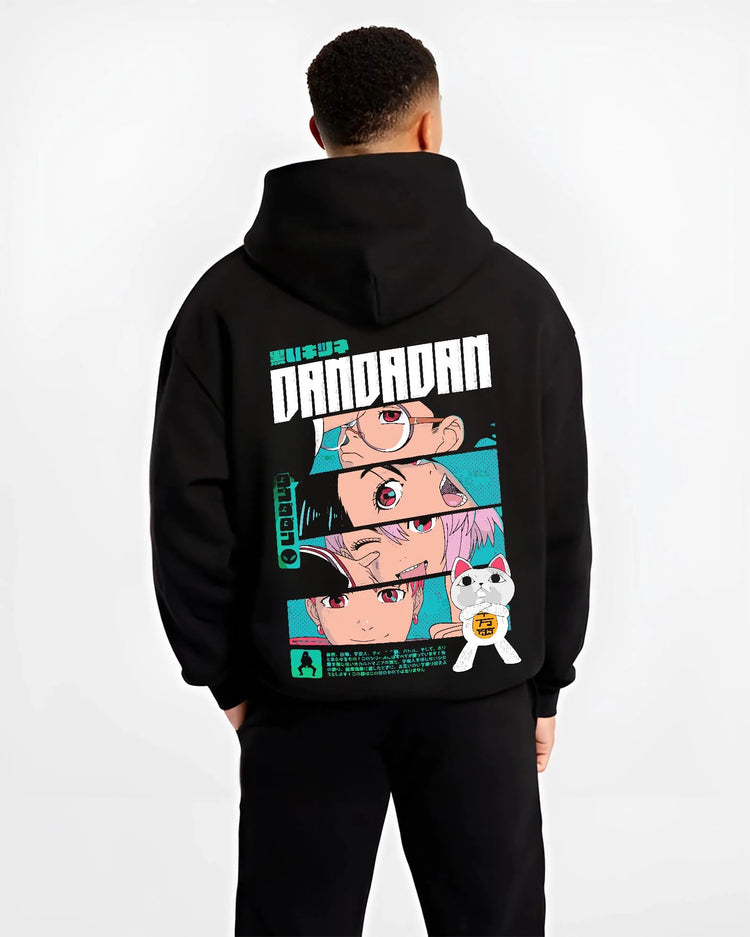 Black hoodie model back view showing Dandadan ensemble: Okarun, Momo, Aira, Jiji and Turbo Granny (cat)