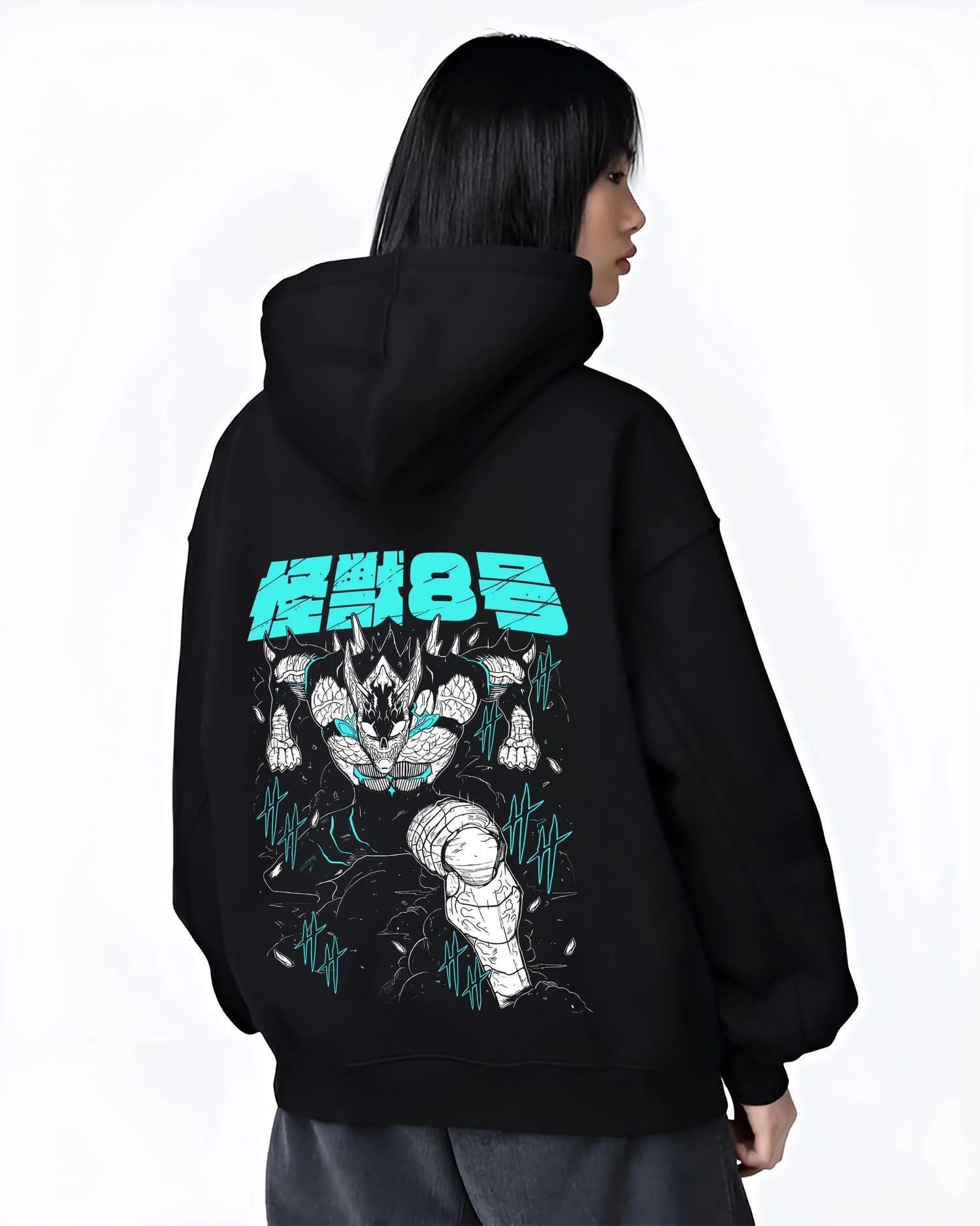 Black hoodie worn by female model, back view with Kaiju No. 8 Hoodie Monstrous Power Surge Pose graphic bold anime graphic.