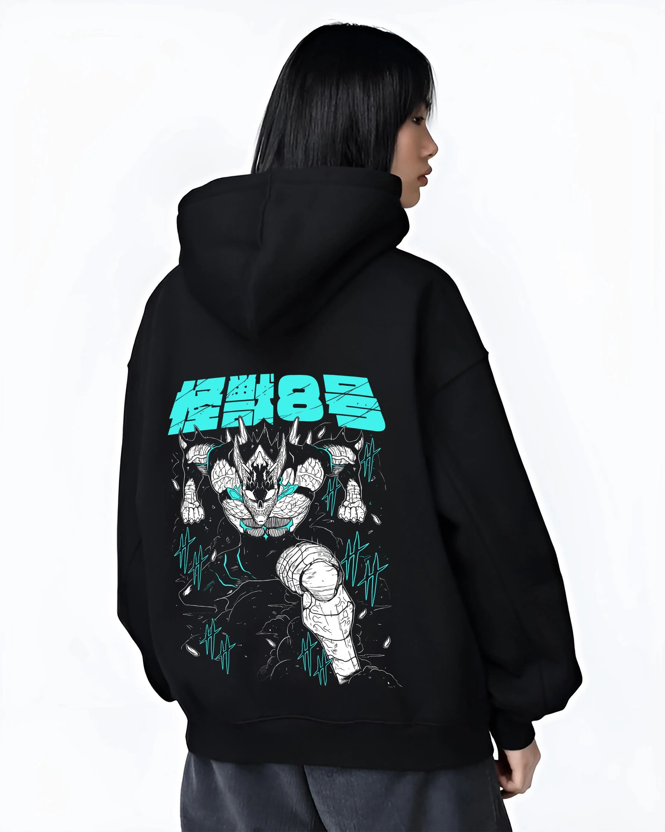 Black hoodie worn by female model, back view with Kaiju No. 8 Hoodie Monstrous Power Surge Pose graphic bold anime graphic.
